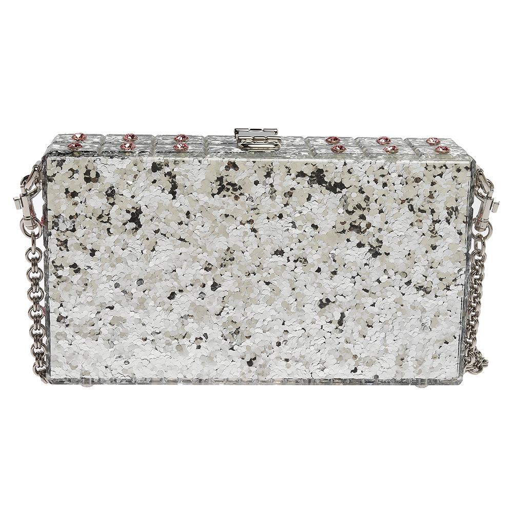 Crafted in Italy, it is made from quality acrylic and comes in a lovely shade of silver. The bag flaunts crystal embellishments, a single chain in silver-tone, and a padlock that carries the brand detail as well as a floral motif. The bag opens to