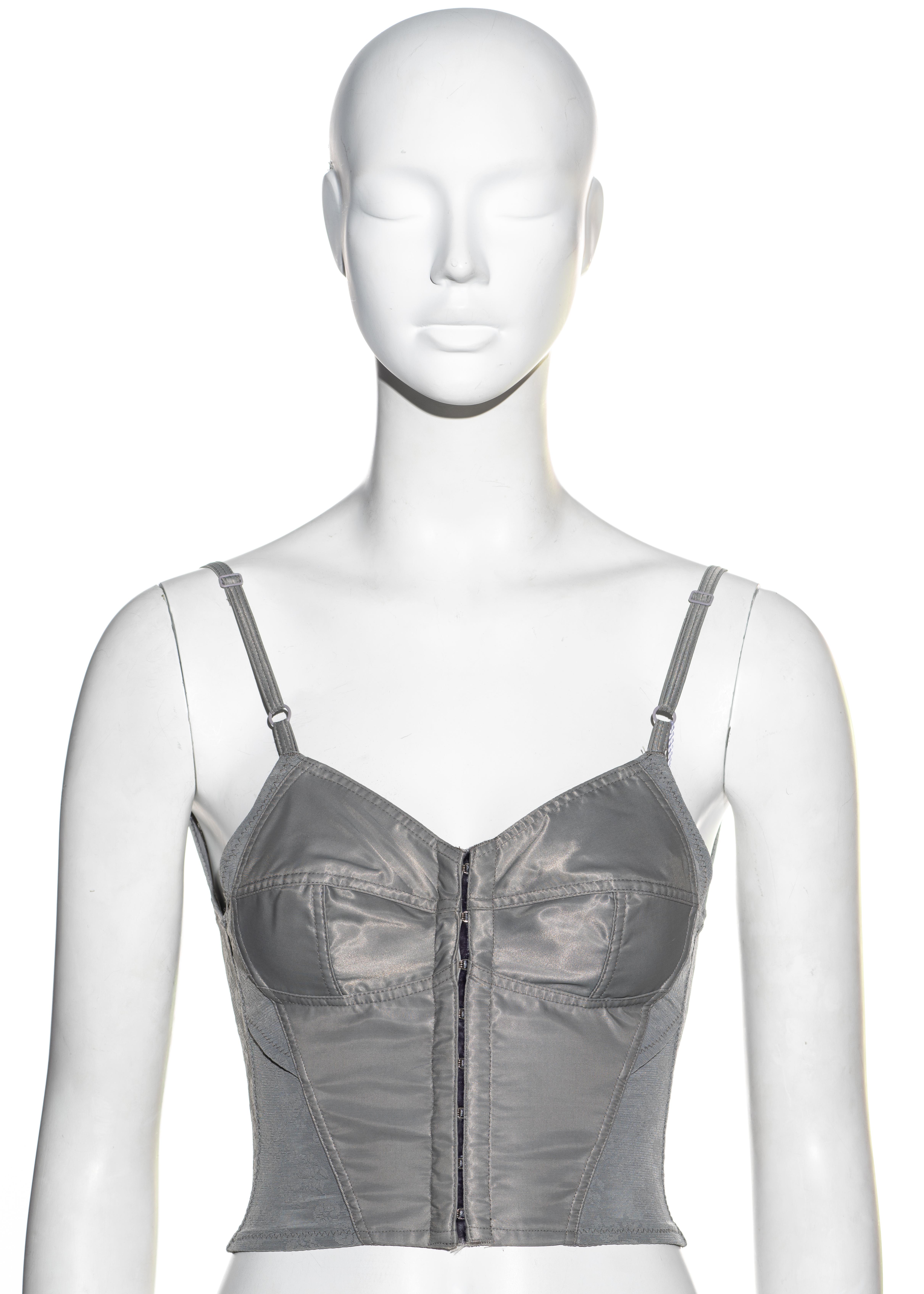 ▪ Dolce & Gabbana silver grey satin and lycra corset top
▪ Metal hook fastenings 
▪ Adjustable shoulder straps 
▪ Floral patterned lycra mesh 
▪ Low back
▪ Tight fit designed to bring the waist in 
▪ IT 40 - FR 36 - UK 8 - US 4
▪ Fall-Winter 1992