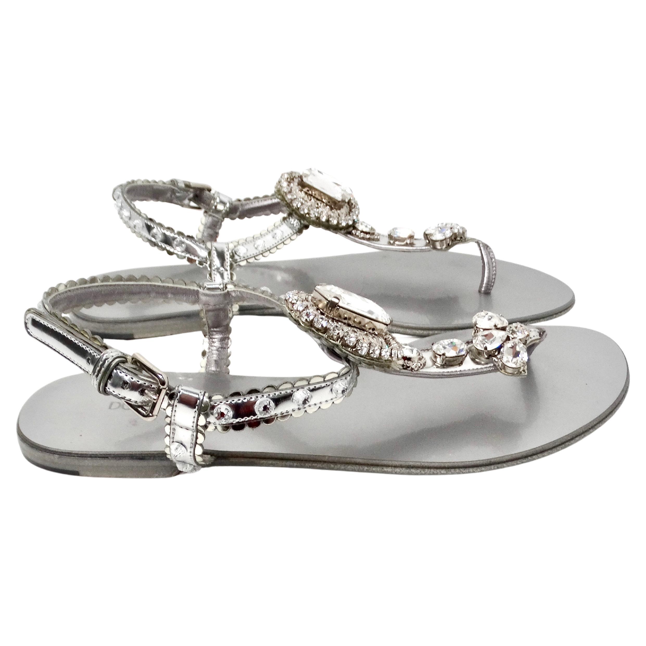 Rehaussez votre garde-robe estivale avec les exquises sandales en cuir argenté de Dolce & Gabbana, ornées de magnifiques cristaux qui captent la lumière à chaque pas. La luxueuse base en cuir argenté apporte une touche sophistiquée, complétant