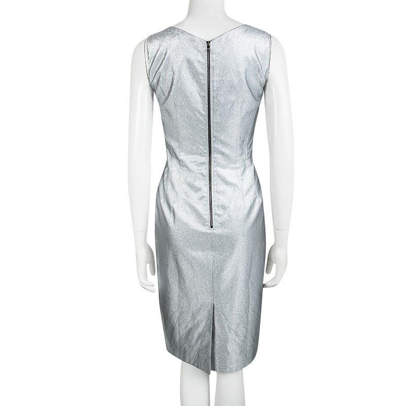 One glance and you'll fall in love with this shimmering silver dress from Dolce and Gabbana. The sheath dress is made of a cotton blend and features a simple structured silhouette. It flaunts a round neckline, subtle pleats at the sides and a long