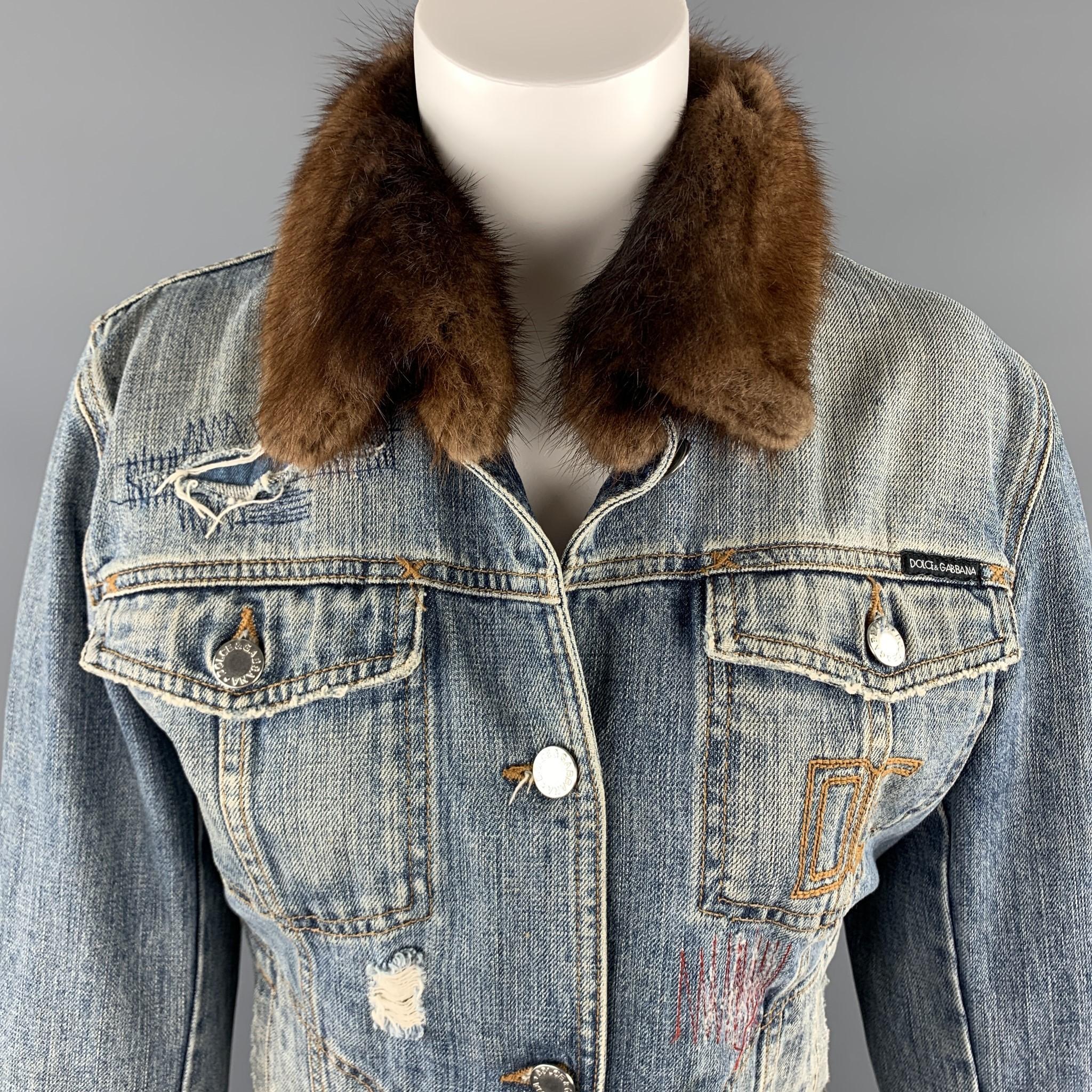 DOLCE & GABBANA trucker jacket comes in a light washed denim with distressing and stitch work throughout, silver tone hardware, and fur collar. Made in Italy.

Excellent Pre-Owned Condition.
Marked: IT 46

Measurements:

Shoulder: 17 in.
Bust: 40