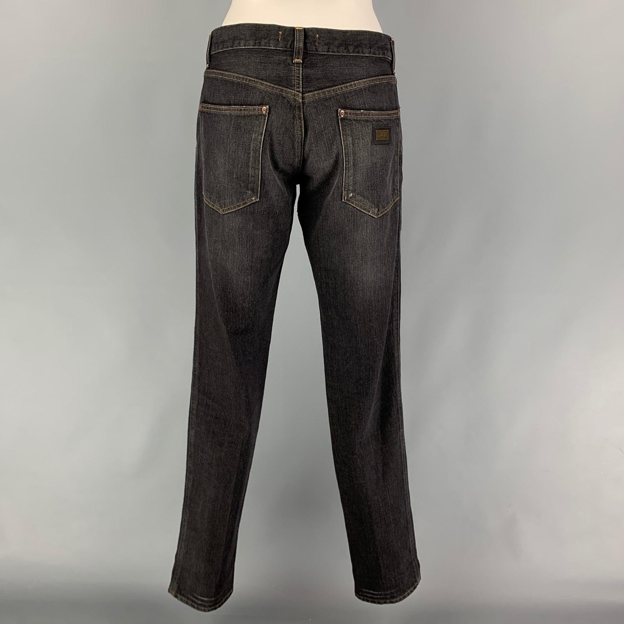 DOLCE & GABBANA jeans comes in a grey distressed cotton denim featuring a straight leg, contrast stitching, back logo emblem, and a zip fly closure. Made in Italy.
 Very Good
 Pre-Owned Condition. 
 

 Marked:  46 
 

 Measurements: 
  Waist: 34