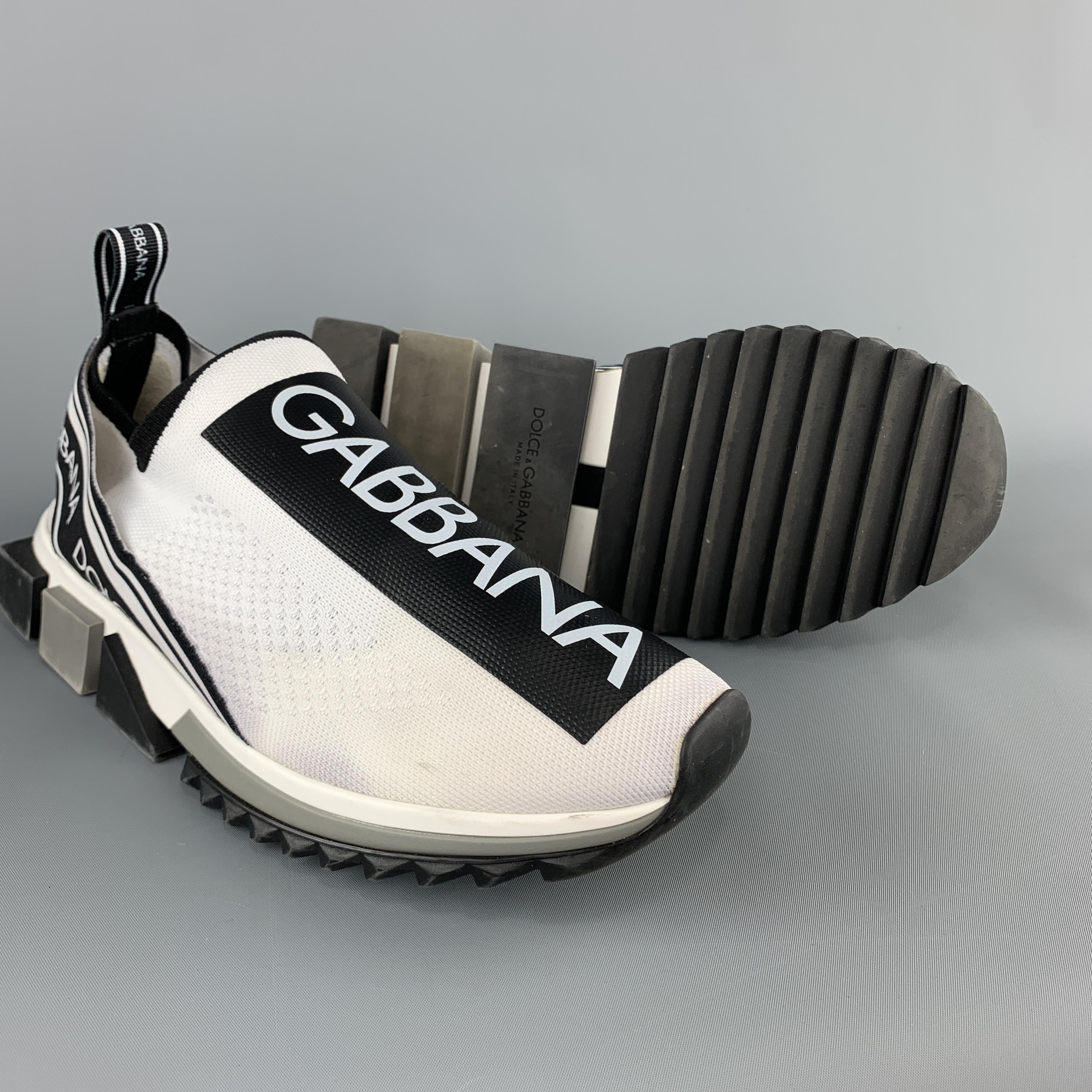 DOLCE & GABBANA Sorrento sneakers come in white knit with logo tape effect motif, printed elastic bands, and grey color block rubber sole. Made in Italy.

Very Good Pre-Owned Condition.
Marked: (no size)

Outsole: 12 x 4.5 in.