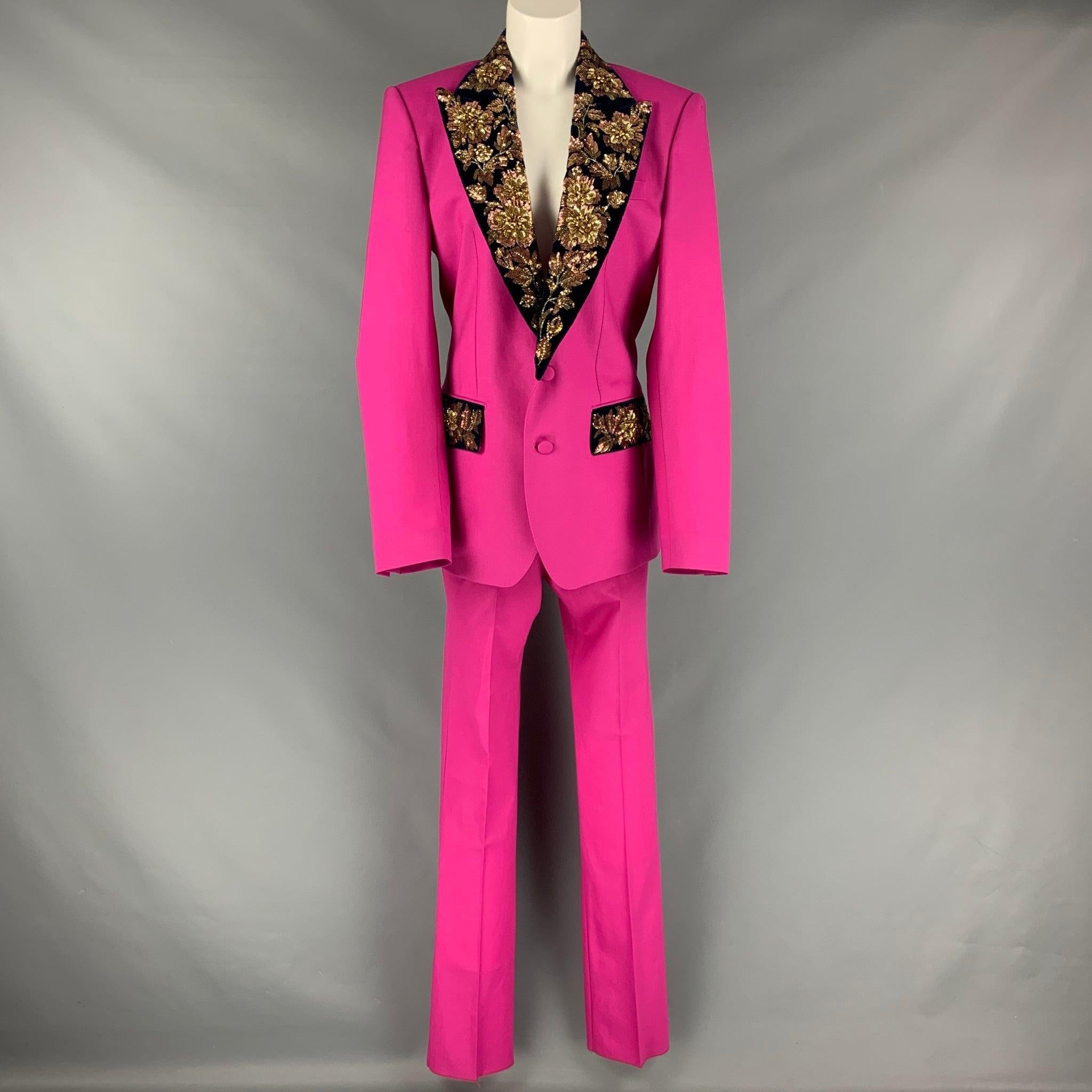 DOLCE & GABBANA pants set comes in a pink and navy wool woven material which includes a gold sequined embroidered, shoulder pads, peak lapel, buttoned closure jacket and matching flat front pants. Made in Italy.Very Good Pre- Owned Conditions.