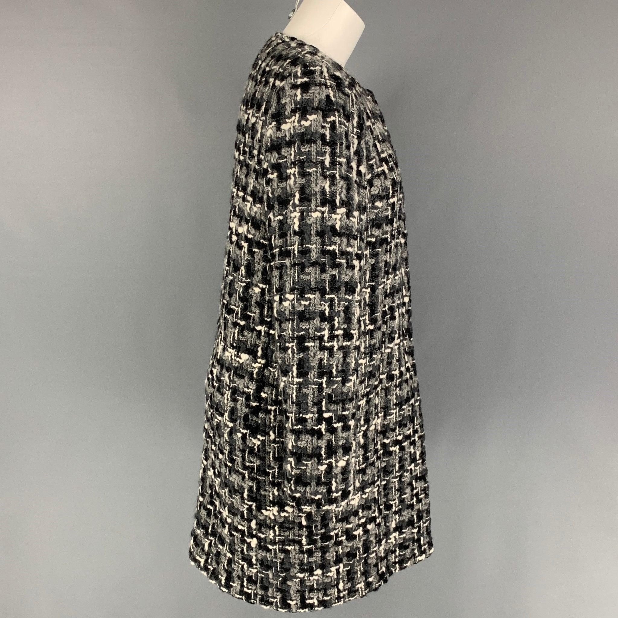 DOLCE & GABBANA coat comes in a black & white tweed wool blend featuring a collarless style, slit pockets, and a hidden placket closure. Made in Italy.
Very Good
Pre-Owned Condition. 

Marked:   38 

Measurements: 
 
Shoulder: 14.5 inches  Bust: 37