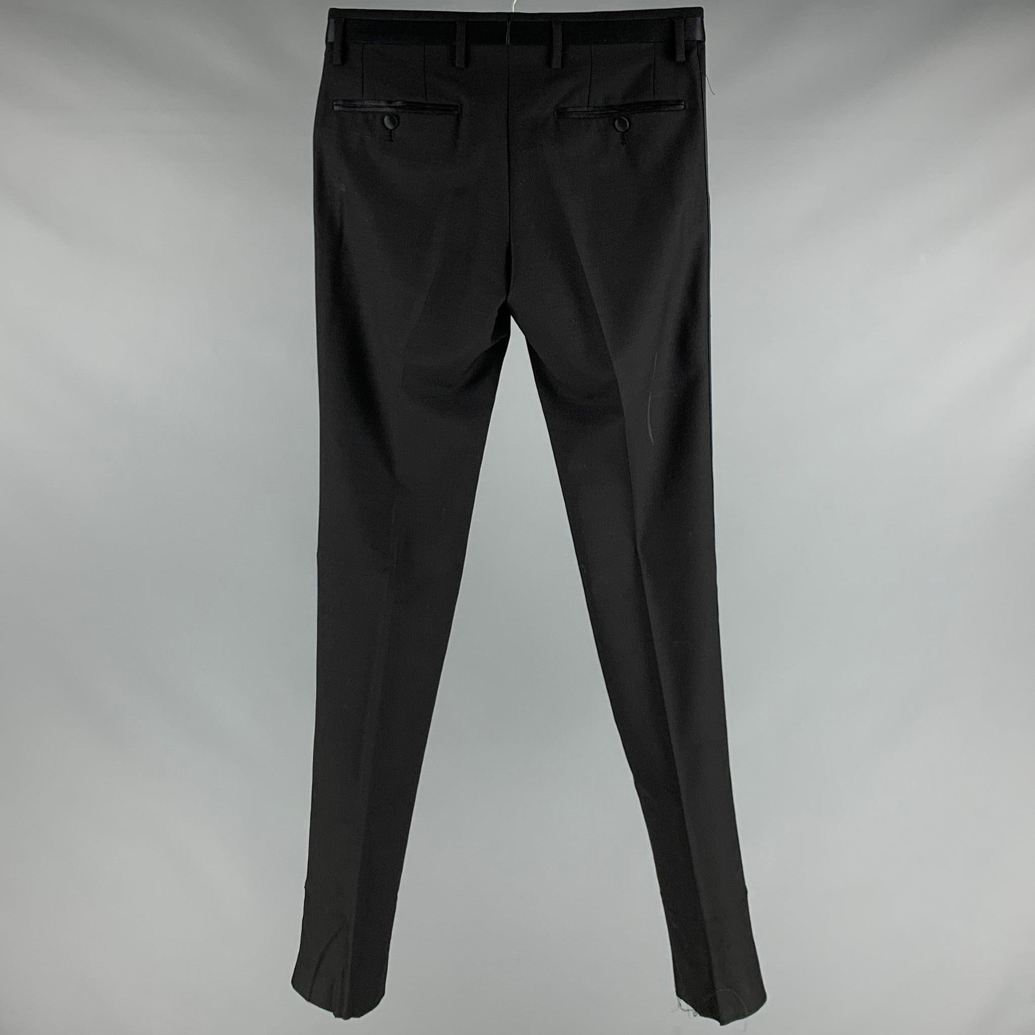 DOLCE & GABBANA dress
pants in a black wool fabric featuring satin waistband and stripes, flat front style, and zip fly closure. Made in Italy.Very Good Pre-Owned Condition. Moderate marks. 

Marked:  IT 44 

Measurements: 
 Waist: 28 inches Rise: 7