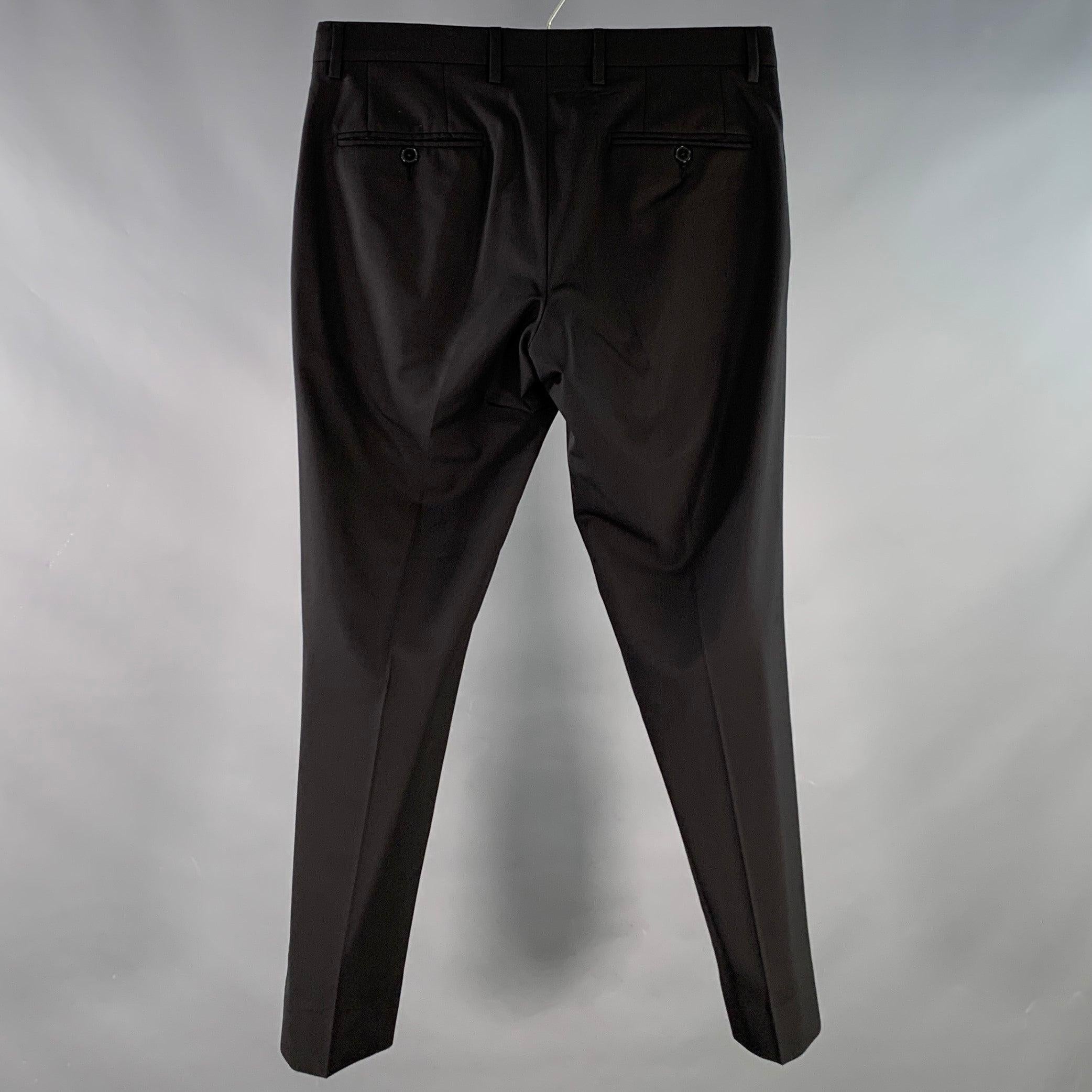 Pantalon habillé DOLCE & GABBANA
en laine mélangée extensible noire, avec un devant plat, une jambe fuselée et une fermeture à glissière. Fabriqué en Italie. Excellent état. 

Marqué :   IT 46 

Mesures : 
  Taille : 30 pouces Taille : 7 pouces