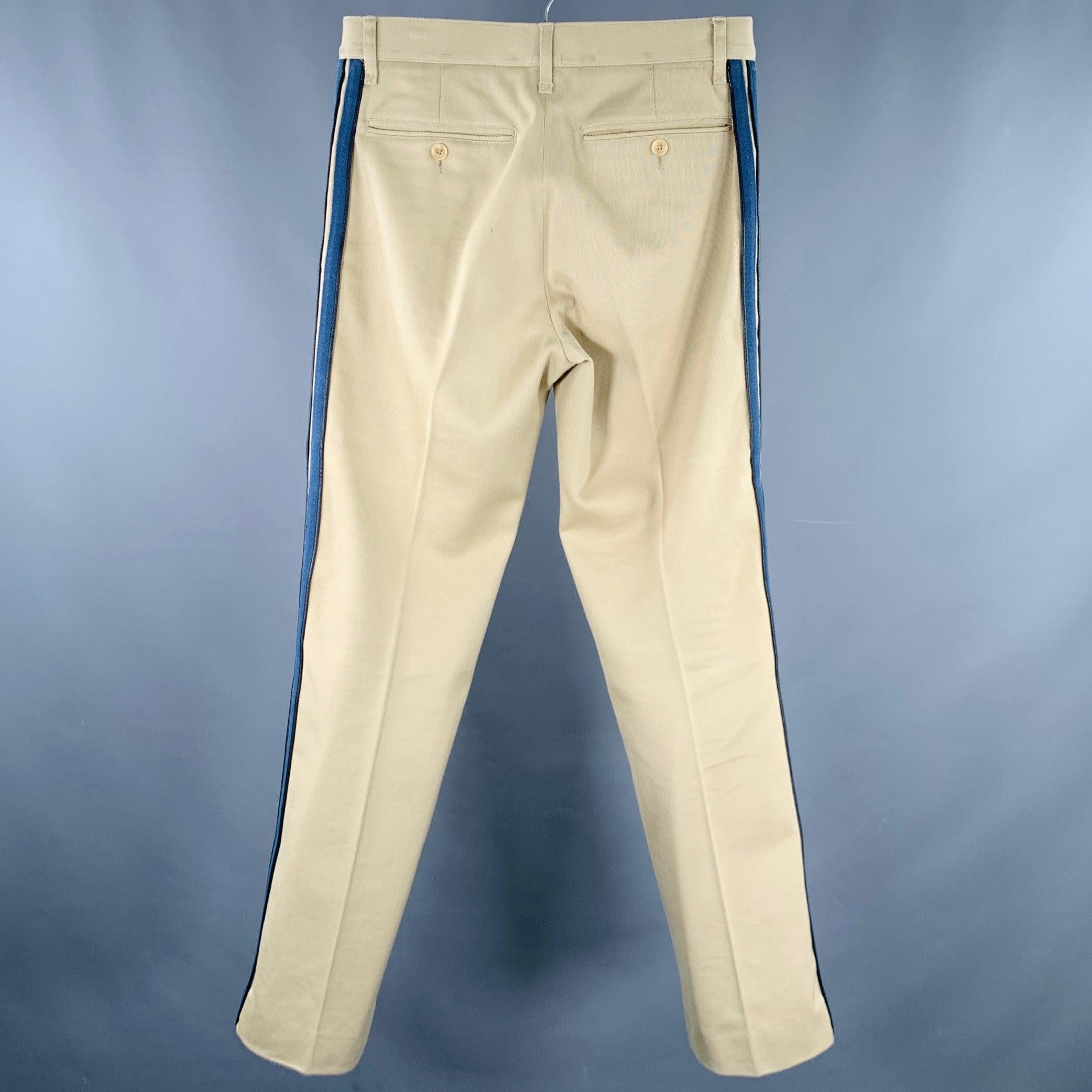 DOLCE & GABBANA casual pants
in a tan cotton twill featuring blue side stripes with black leather trim, flat front style, and zip fly closure. Made in Italy.Very Good Pre-Owned Condition. Multiple marks at waistband on back. 

Marked:   IT 46