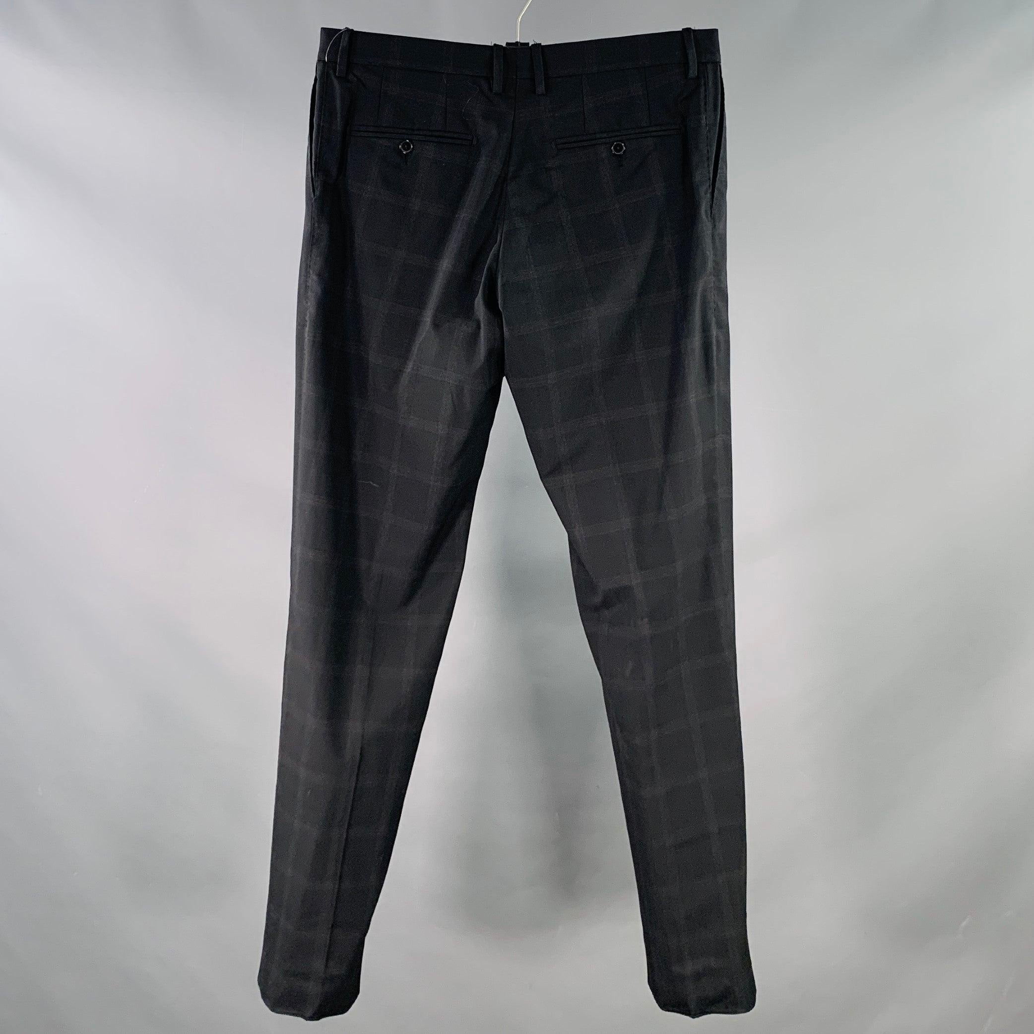 DOLCE & GABBANA dress pants
in a black wool blend woven fabric featuring a windowpane pattern, tapered leg, and zip fly closure. Made in Italy. Note: this garment has been professionally altered. Please double check measurements.Excellent Pre-Owned