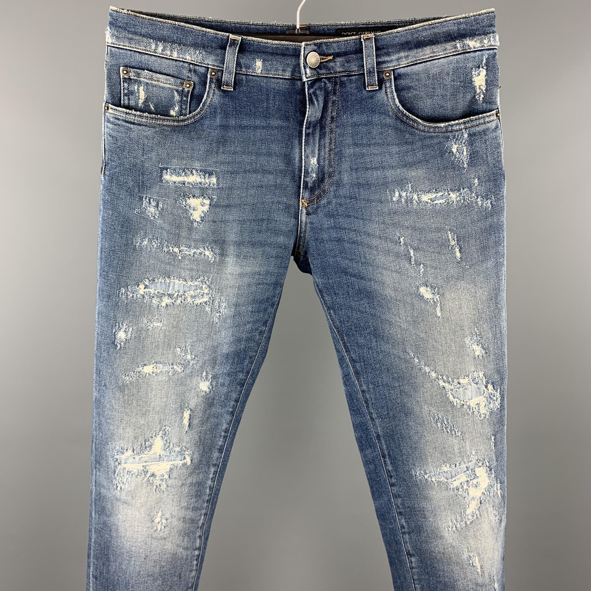 DOLCE & GABBANA jeans comes in a blue distressed denim featuring slim fit and a zip fly closure. Made in Italy.

Excellent Pre-Owned Condition.
Marked: IT 48

Measurements:

Waist: 34 in.
Rise: 9 in. 
Inseam: 28 in. 