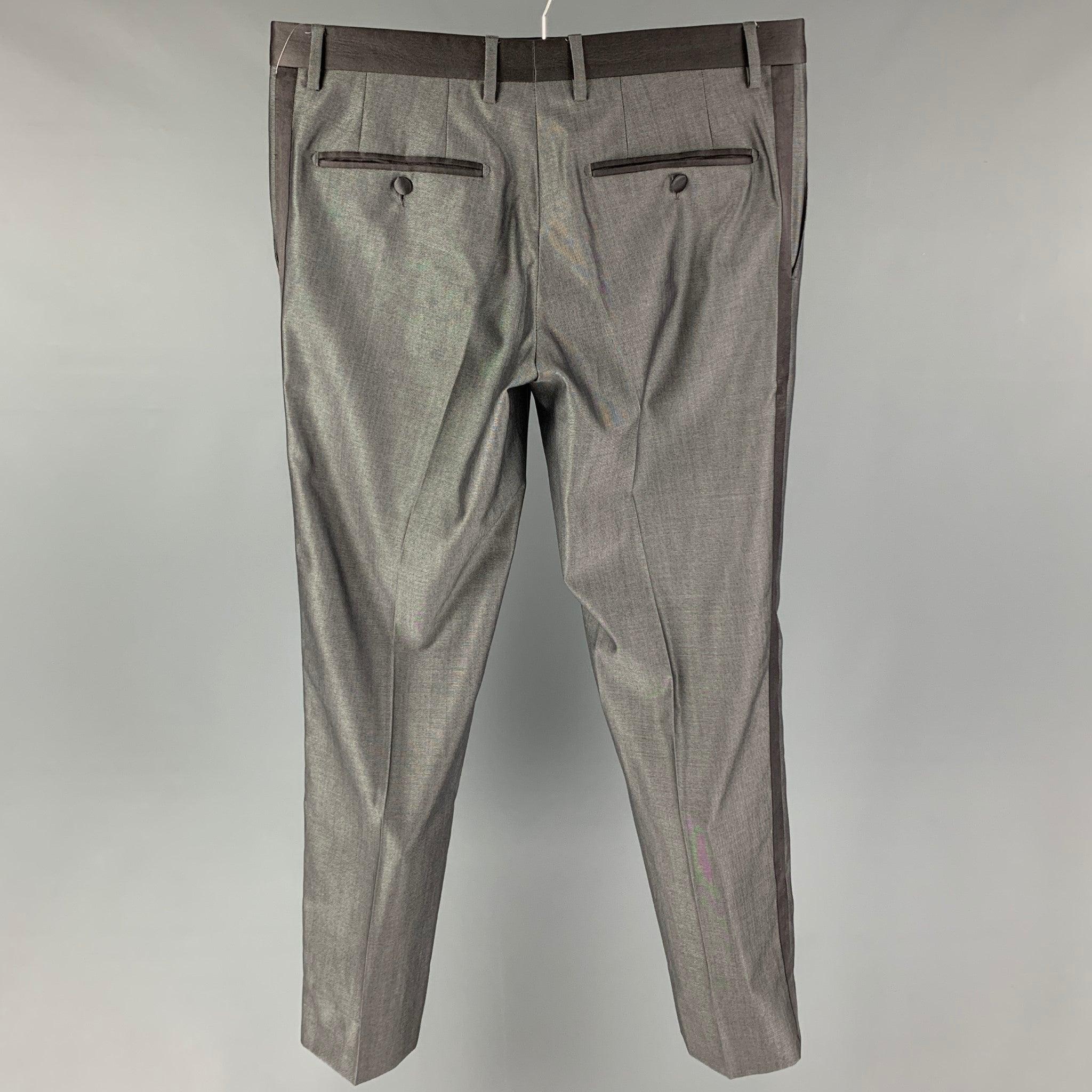 DOLCE & GABBANA dress pants comes in a grey wool / silk featuring a satin tim, slim fit, and a zip fly closure. Made in Italy.
Excellent
Pre-Owned Condition. 

Marked:   48 

Measurements: 
  Waist: 34 inches  Rise: 9 inches  Inseam: 31 inches 
  
 