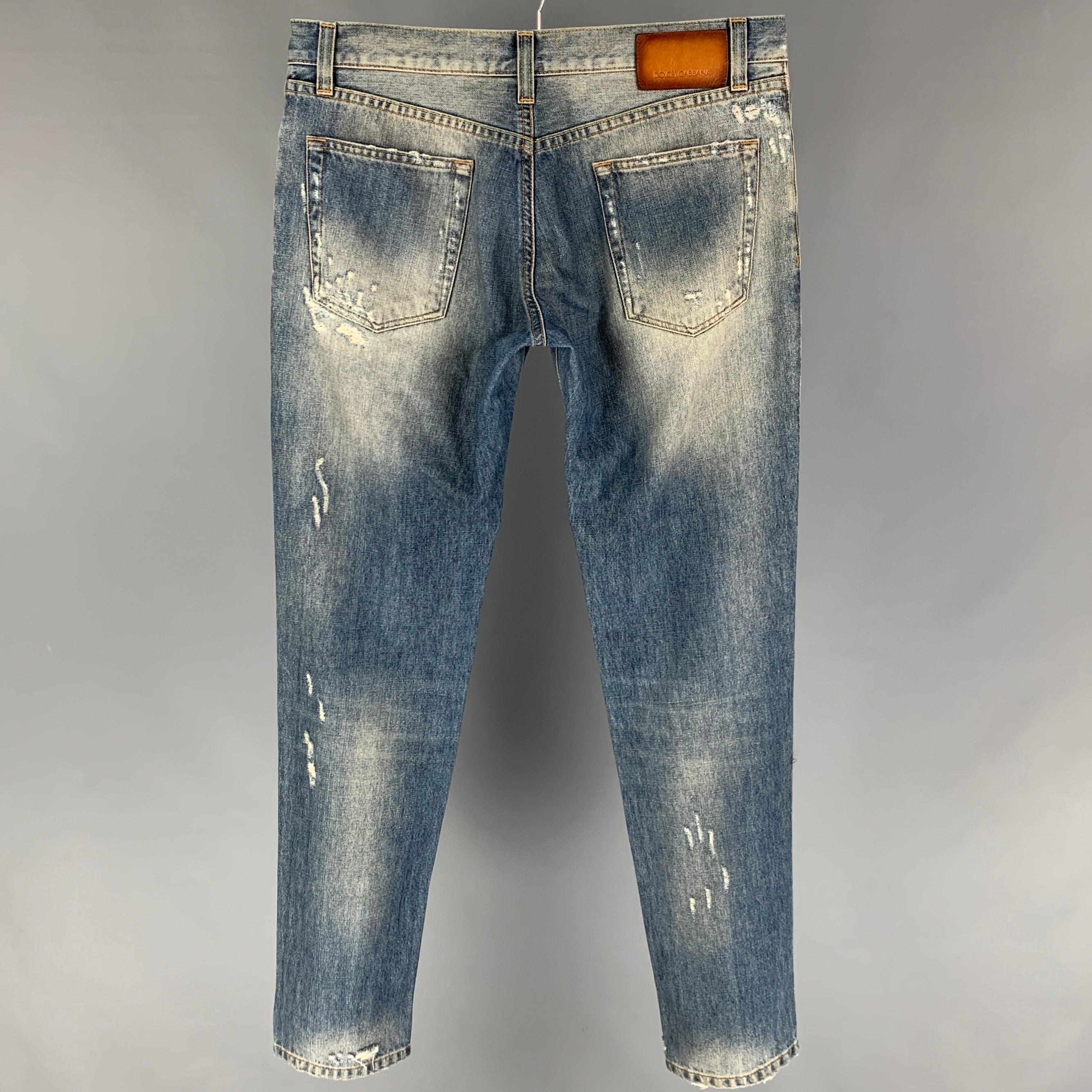 DOLCE & GABBANA jeans comes in a light blue cotton featuring distressed details, slim fit, contrast stitching, and a zip fly closure. Made in Italy.
 Very Good
 Pre-Owned Condition. 
 

 Marked:  48 
 

 Measurements: 
  Waist: 34 inches Rise: 9