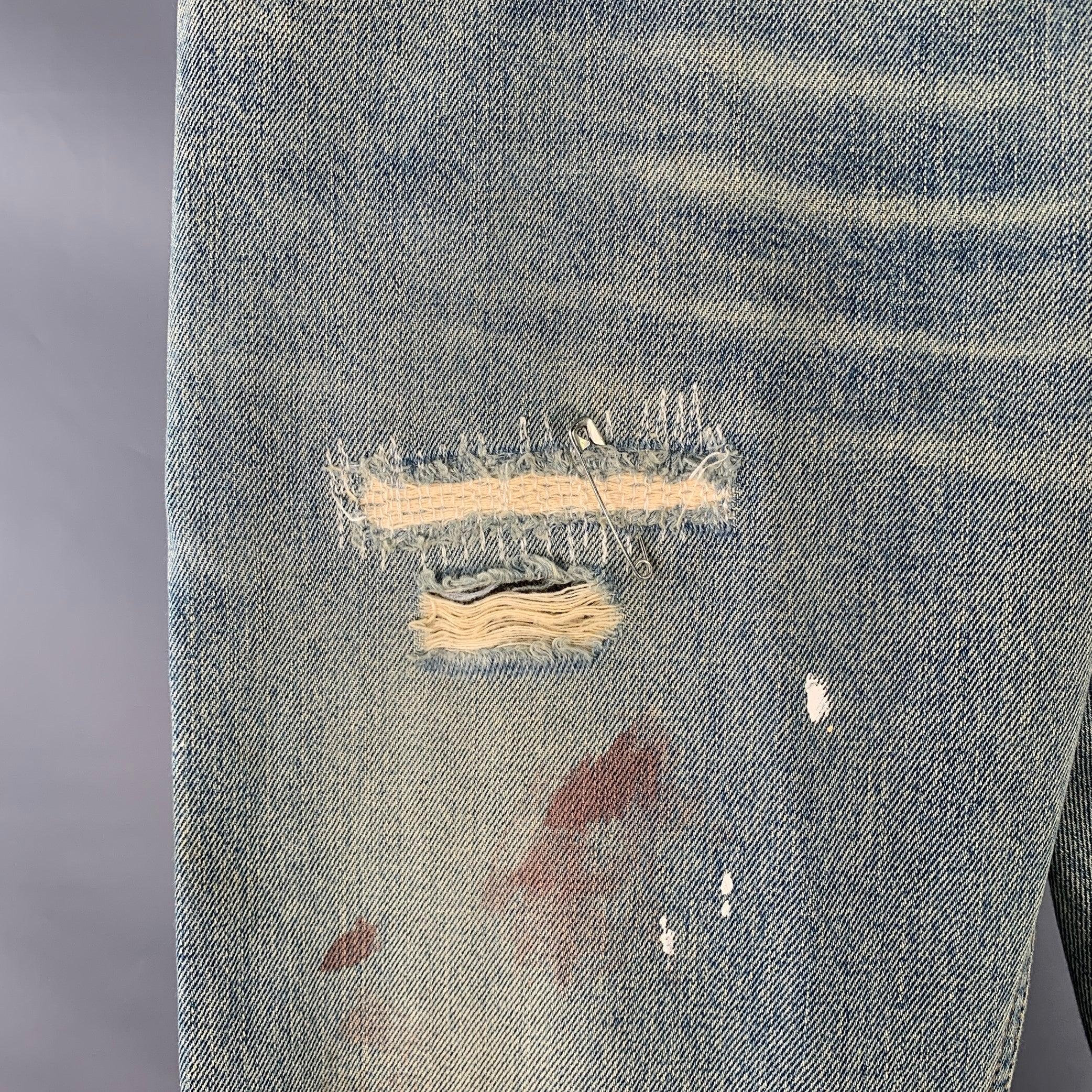 DOLCE & GABBANA jeans
in a blue denim featuring a distressed style, handpainted design which reads 