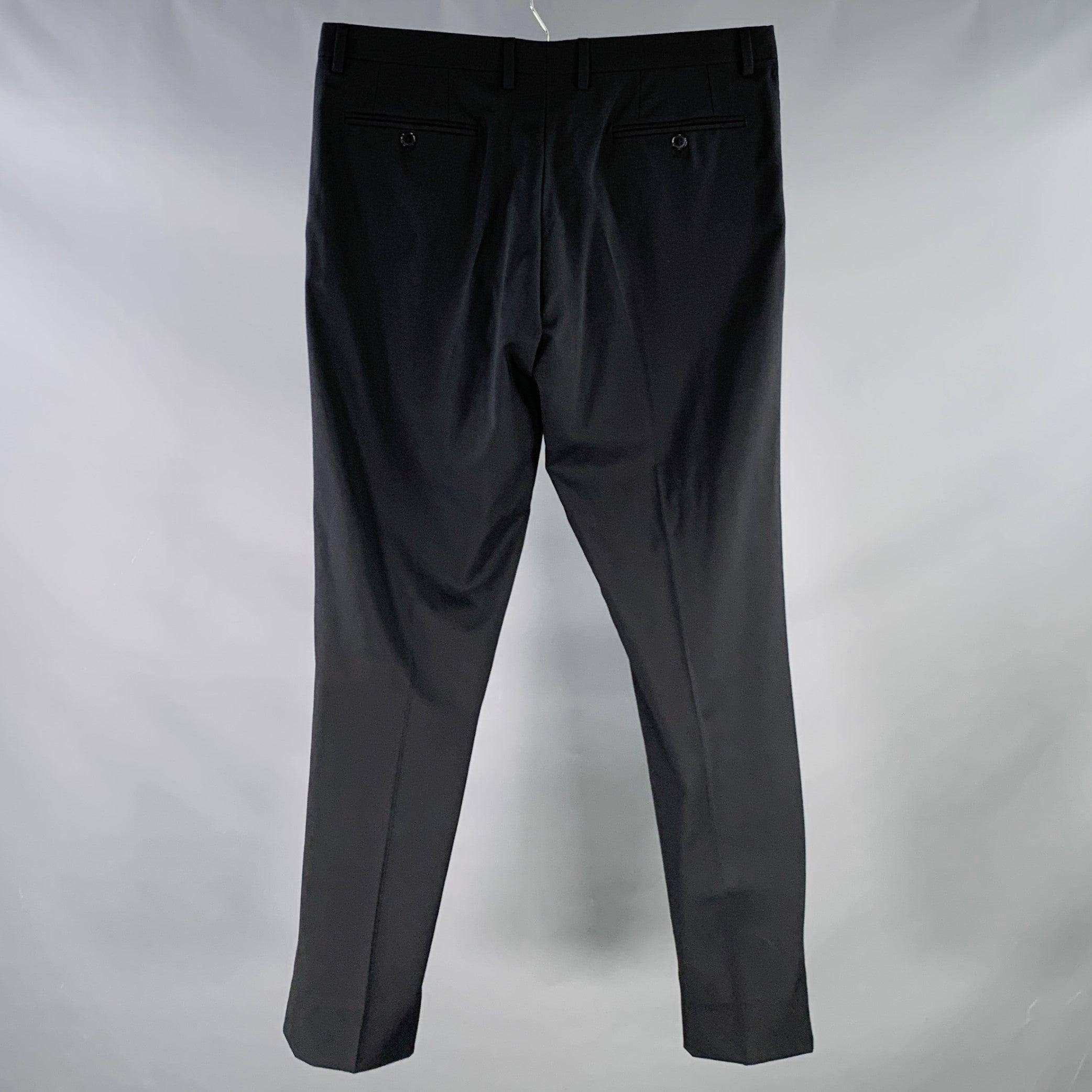 DOLCE & GABBANA dress pants
in a black wool blend fabric featuring a flat front, straight leg, and zip fly closure. Made in Italy.Excellent Pre-Owned Condition.  

Marked:   IT 50 

Measurements: 
  Waist: 34 inches Rise: 8 inches Inseam: 31 inches
