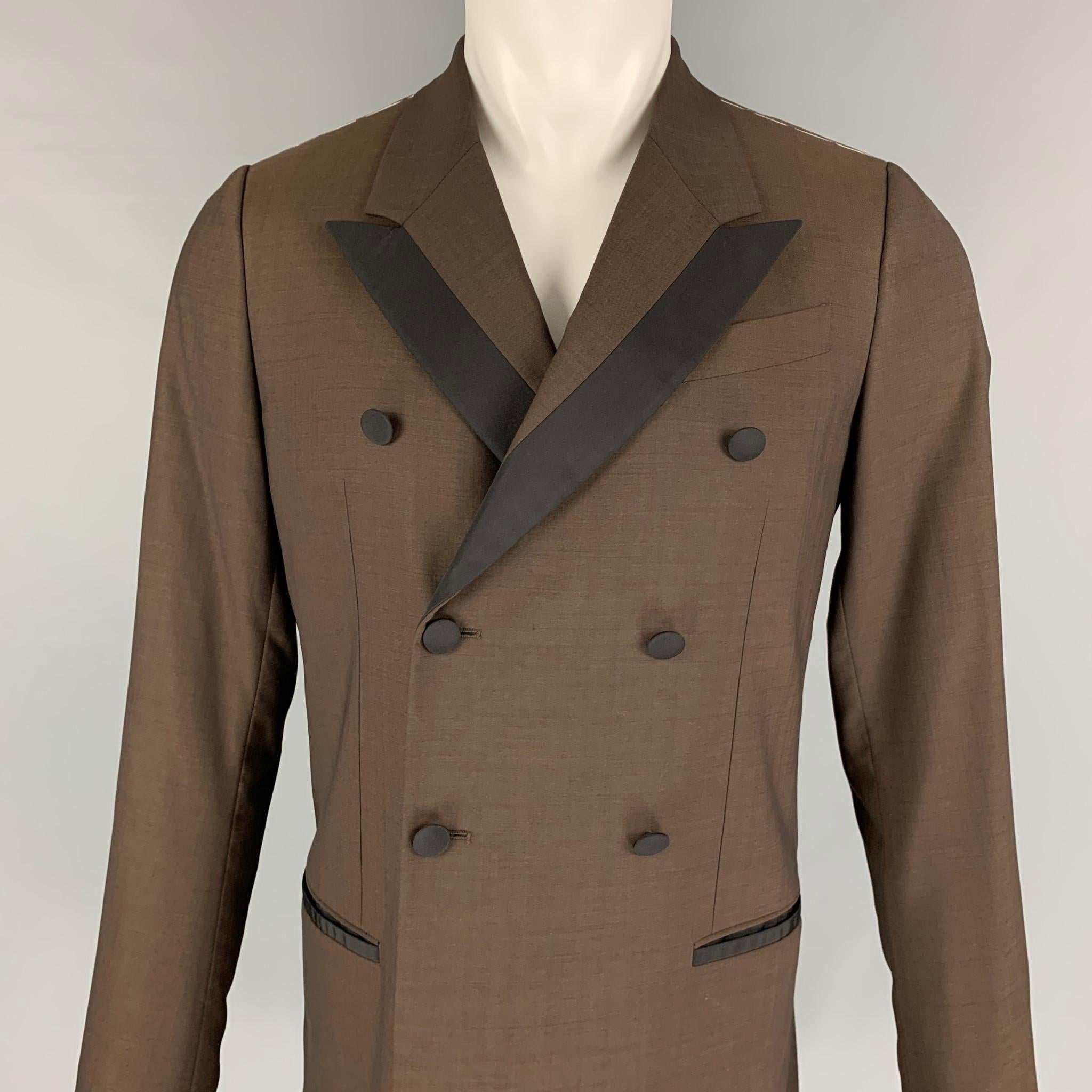 DOLCE & GABBANA coat comes in a brown & black wool blend with a full liner featuring a peak lapel, slit pockets, single back vent, and a double breasted closure. Made in Italy. 

Excellent Pre-Owned Condition.
Marked: 44

Measurements:

Shoulder: