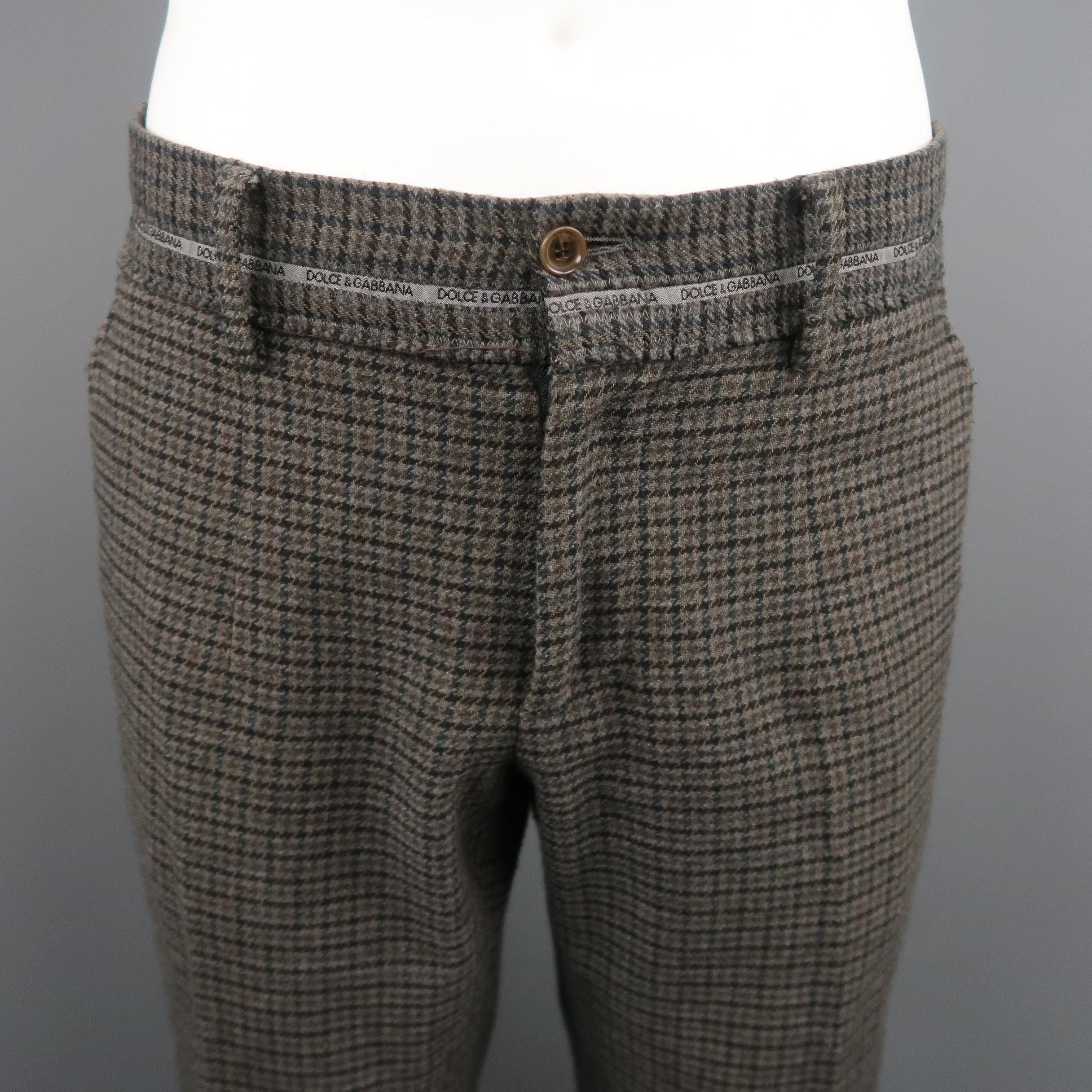 DOLCE & GABBANA Casual pants comes in grey and brown tones in a houndstooth wool / cotton material, with a wide waistband, buttoned pockets and zip fly. Made in Italy.
 
Excellent Pre-Owned Condition.
Marked: 50 IT
 
Measurements:
 
Waist: 35