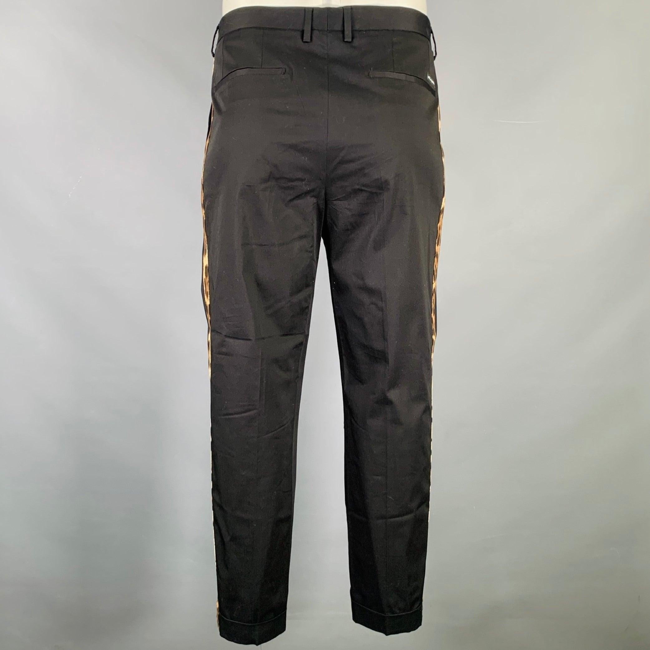 DOLCE & GABBANA dress pants
in a black cotton blend fabric featuring leopard print side stripes, cuffed style, and zip fly closure. Made in Italy.Excellent Pre-Owned Condition. 

Marked:   54 

Measurements: 
  Waist: 36 inches Rise: 9.5 inches