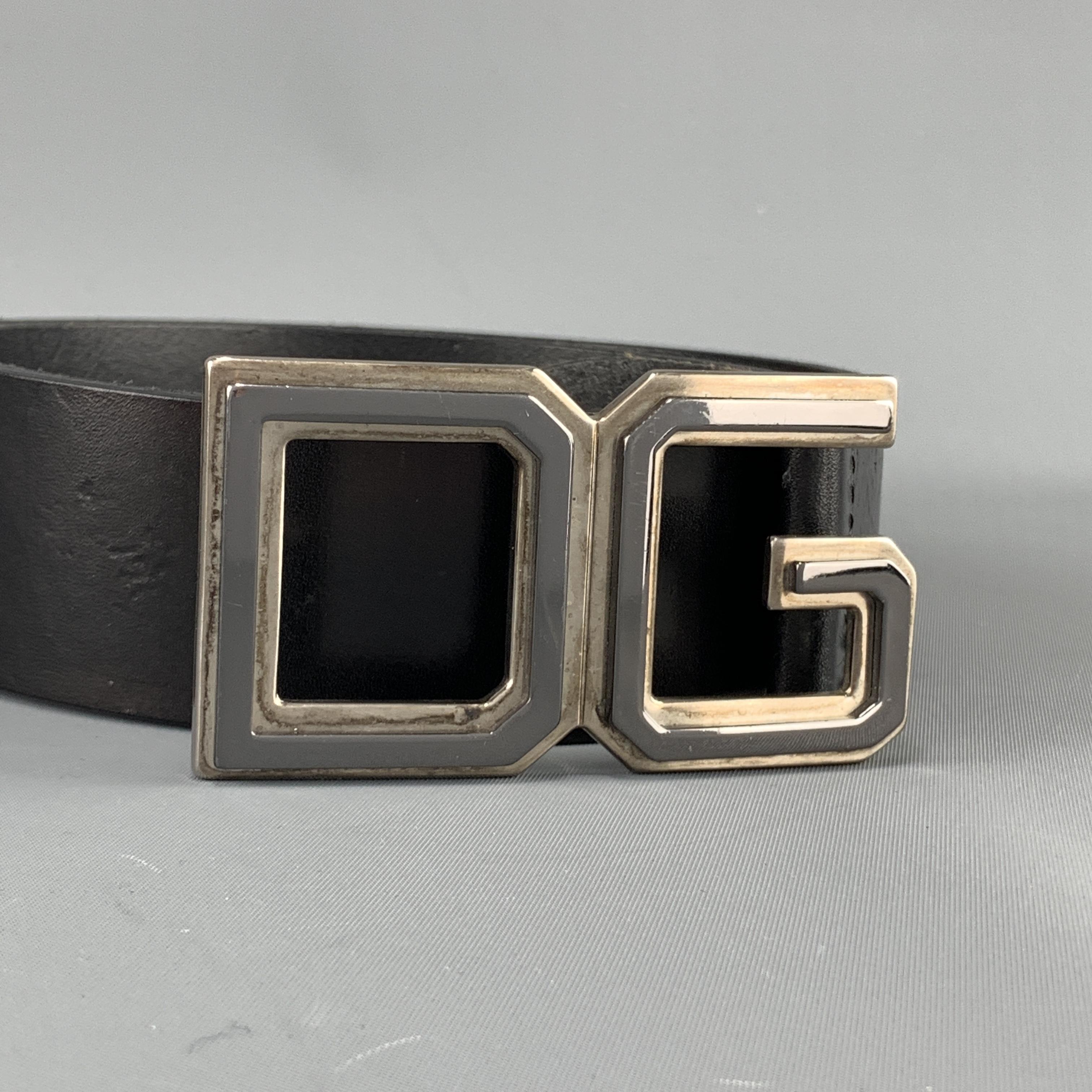 DOLCE & GABBANA belt features a black leather strap with a dark silver tone sporty font DG buckle. Minor wear. As-is. Made in Italy.

Good Pre-Owned Condition.
Marked: 95 cm - 38 in.

Length: 43.75 in.
Width: 1.5
Fits: 35.5-.9.5 in.
Buckle: 8.5 x 5
