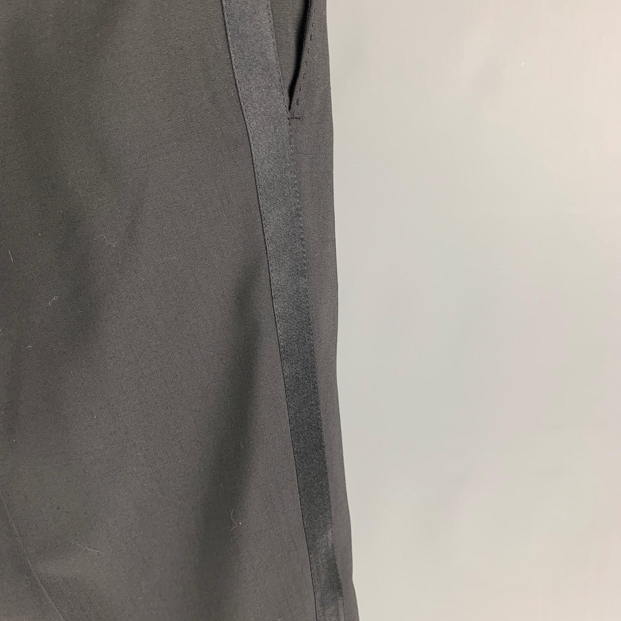 DOLCE & GABBANA tuxedo dress pants comes in a black wool blend featuring a flat front, stripe trim, and a zip fly closure. Made in Italy.
Very Good
Pre-Owned Condition. 

Marked:   54 

Measurements: 
  Waist: 38 inches  Rise: 9.5 inches  Inseam: 28