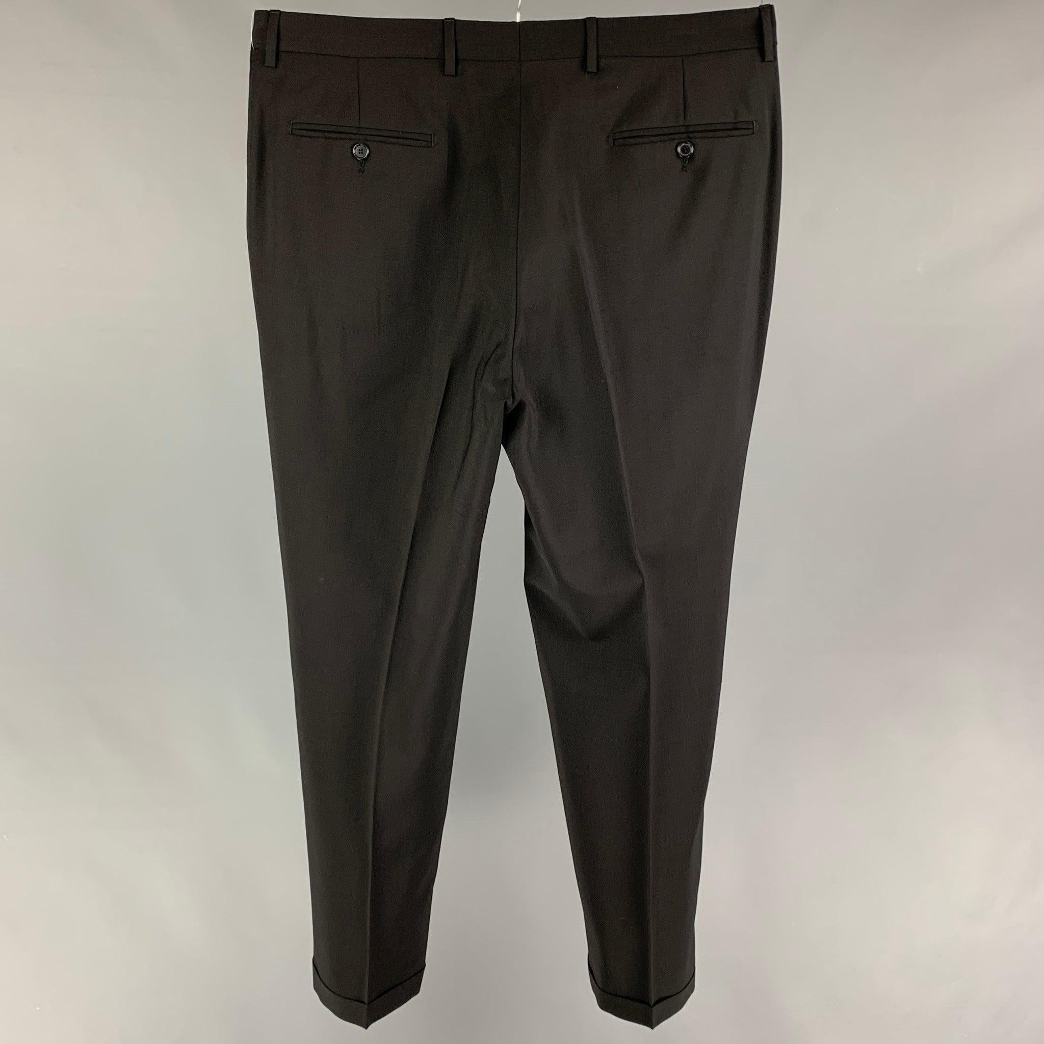 DOLCE & GABBANA dress pants comes in a black wool blend featuring a flat front and a zip fly closure. Made in Italy.
Very Good
Pre-Owned Condition. 

Marked:   54 

Measurements: 
  Waist: 38 inches  Rise: 12 inches  Inseam: 32 inches 

  
  
