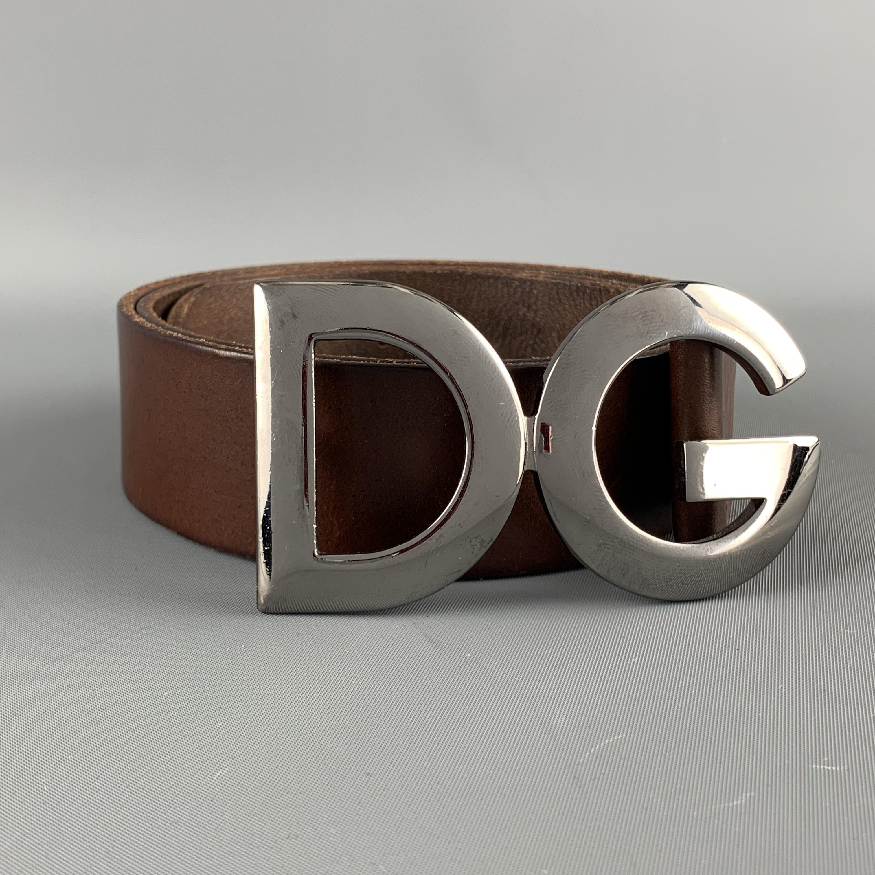 DOLCE & GABBANA belt features a brown leather strap with a dark silver tone DG buckle. Minor wear. As-is. Made in Italy.

Very Good Pre-Owned Condition.
Marked: 95 cm - 38 in.

Length:44 in.
Width: 1.5 in.
Fits: 36-40 in.
Buckle: 10 x 5.5 cm.