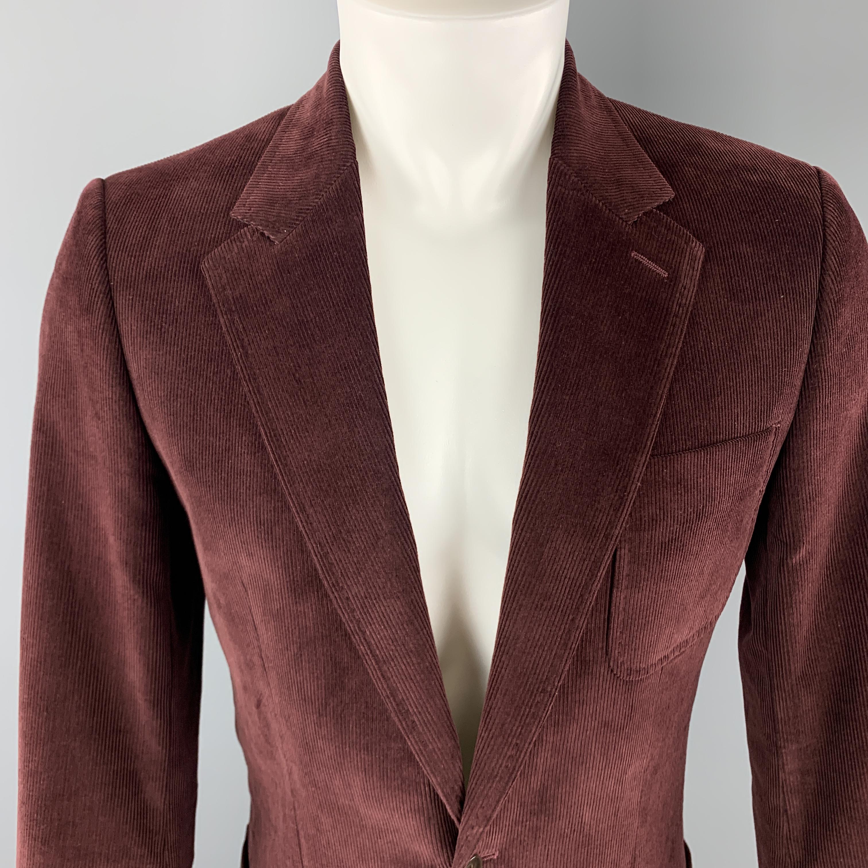 DOLCE & GABBANA sport coat comes in burgundy corduroy with a notch lapel, single breasted, two button front, and patch pockets. Made in Italy.

Excellent Pre-Owned Condition.
Marked: IT 46

Measurements:

Shoulder: 17 in.
Chest: 38 in.
Sleeve: 26