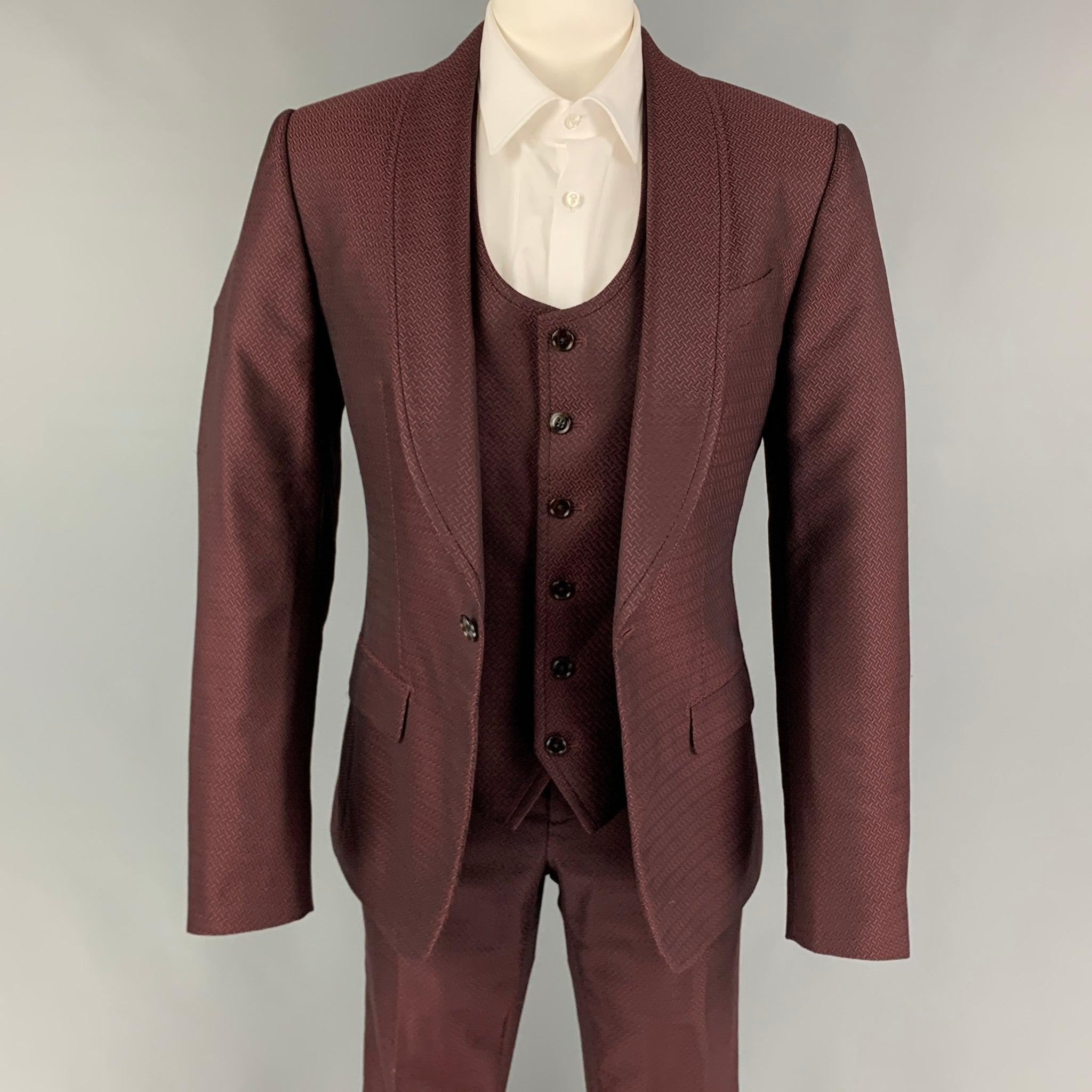 DOLCE & GABBANA 3 Piece
suit comes in a burgundy jacquard wool / silk wth a full liner and includes a single breasted, single button sport coat with shawl collar and a matching vest and flat front trousers. Made in Italy. Excellent Pre-Owned