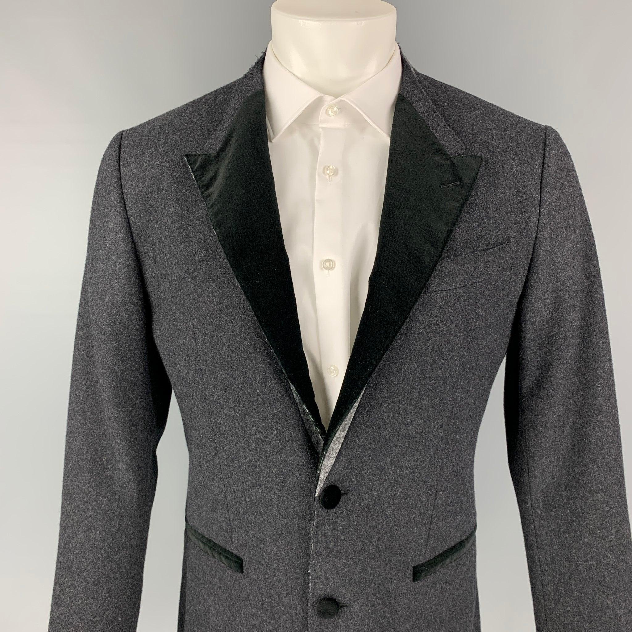 DOLCE & GABBANA sport coat comes in a charcoal & black wool blend with a half liner featuring a deconstructed lapel, slit pockets, double back vent, and a double button closure. Made in Italy.
Excellent
Pre-Owned Condition.  

Marked:   46