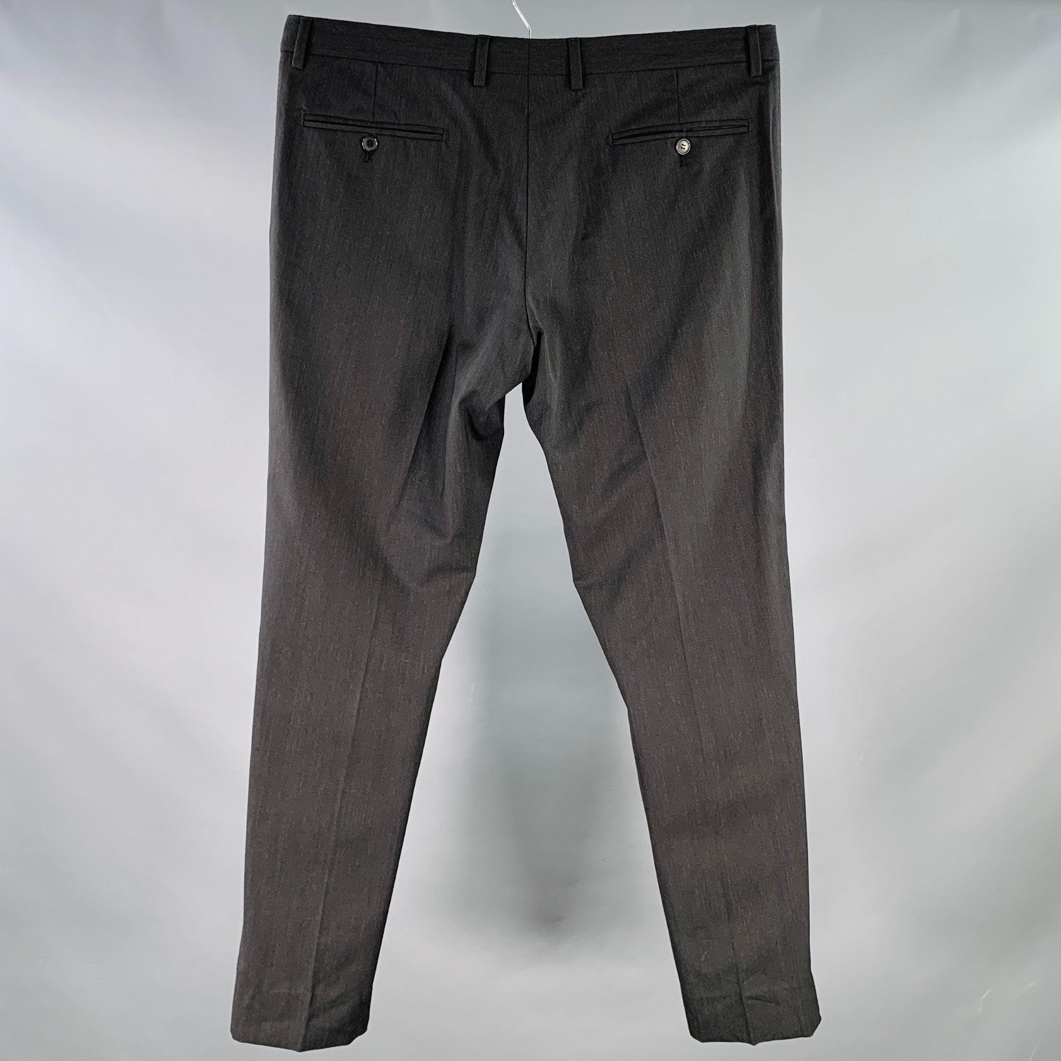 DOLCE & GABBANA dress pants
in a charcoal grey wool stretch blend fabric featuring a flat front style, tapered leg, and zip fly closure.
Made in Italy.Excellent Pre-Owned Condition.  

Marked:   IT 52 

Measurements: 
  Waist: 36 inches Rise: 8.5