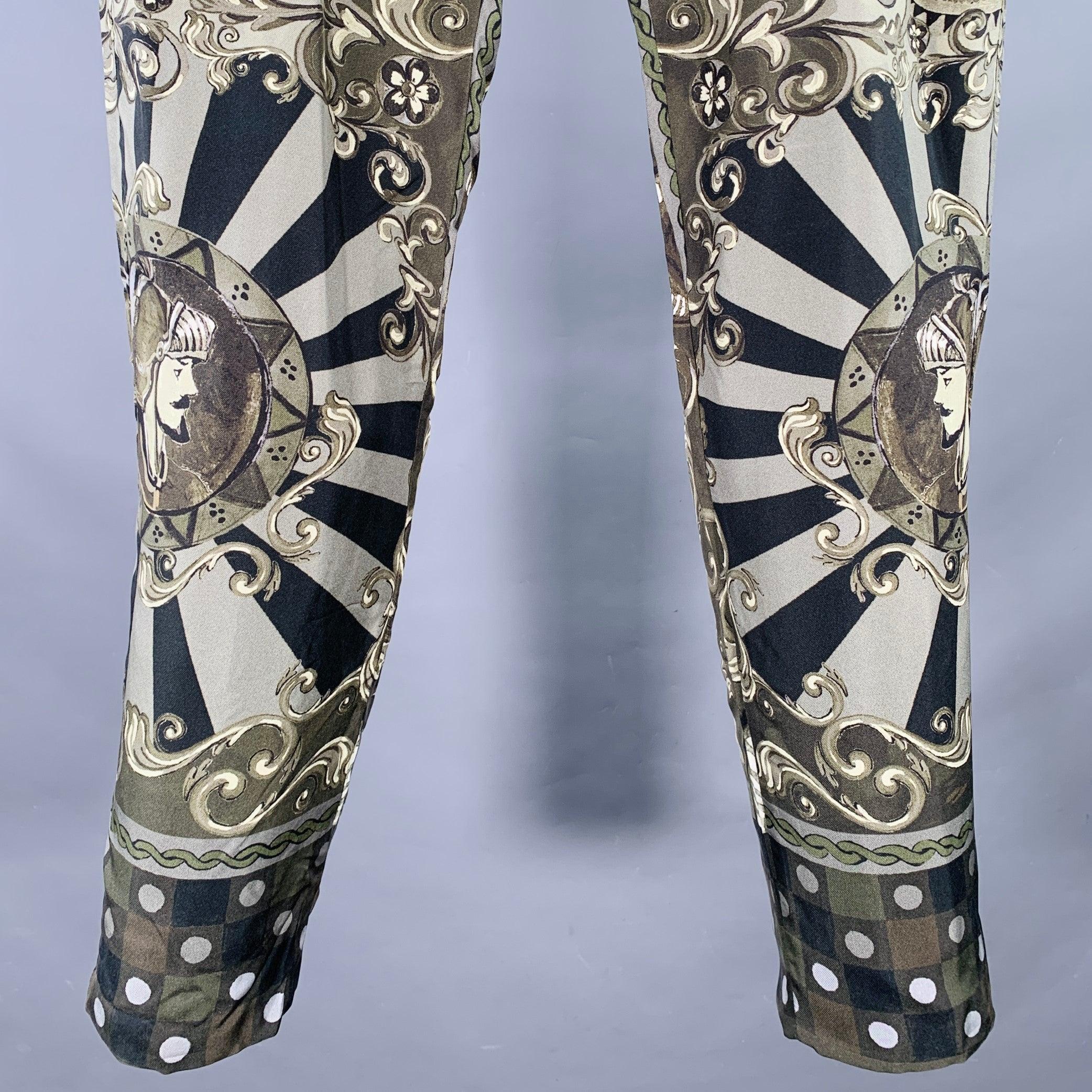 DOLCE & GABBANA dress pants
in an olive green and black silk featuring an all over abstract print, tapered leg, and zip fly closure. Made in Italy.Very Good Pre-Owned Condition. Minor snagging which is hard-to-see due to print. 

Marked:   IT 52