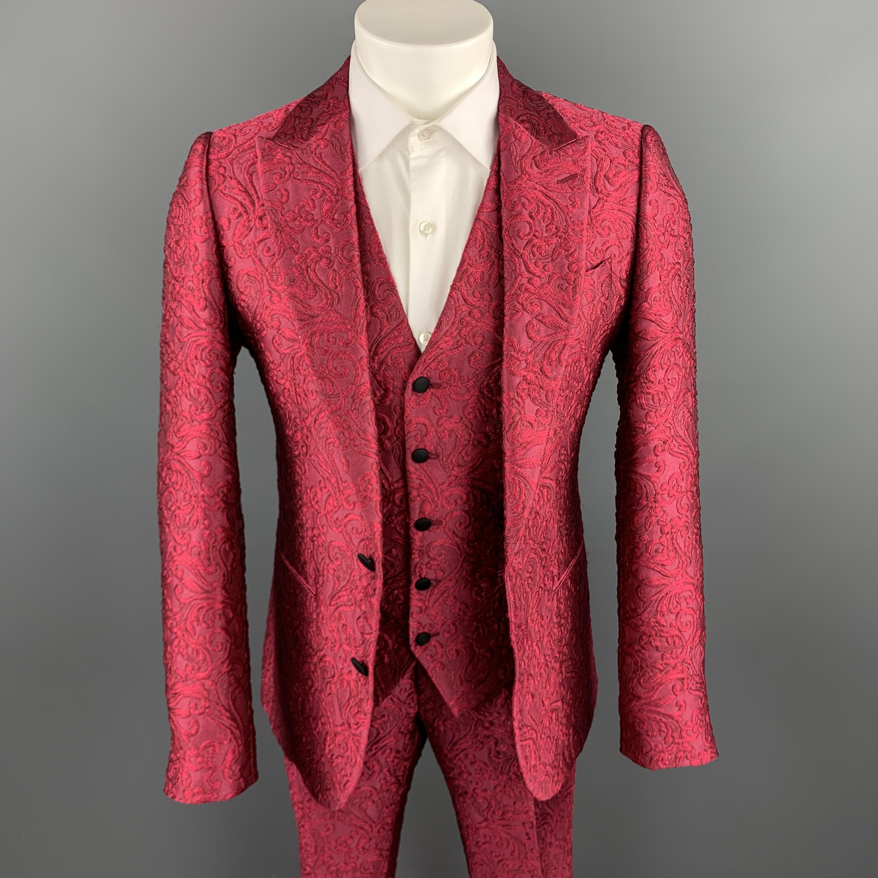 DOLCE & GABBANA suit comes in a vibrant raspberry fuchsia pink brocade and includes a single breasted, two button, peak lapel sport coat, matching V neck vest, and tailored dress pants. Made in Italy.

New with Tags.
Marked: IT