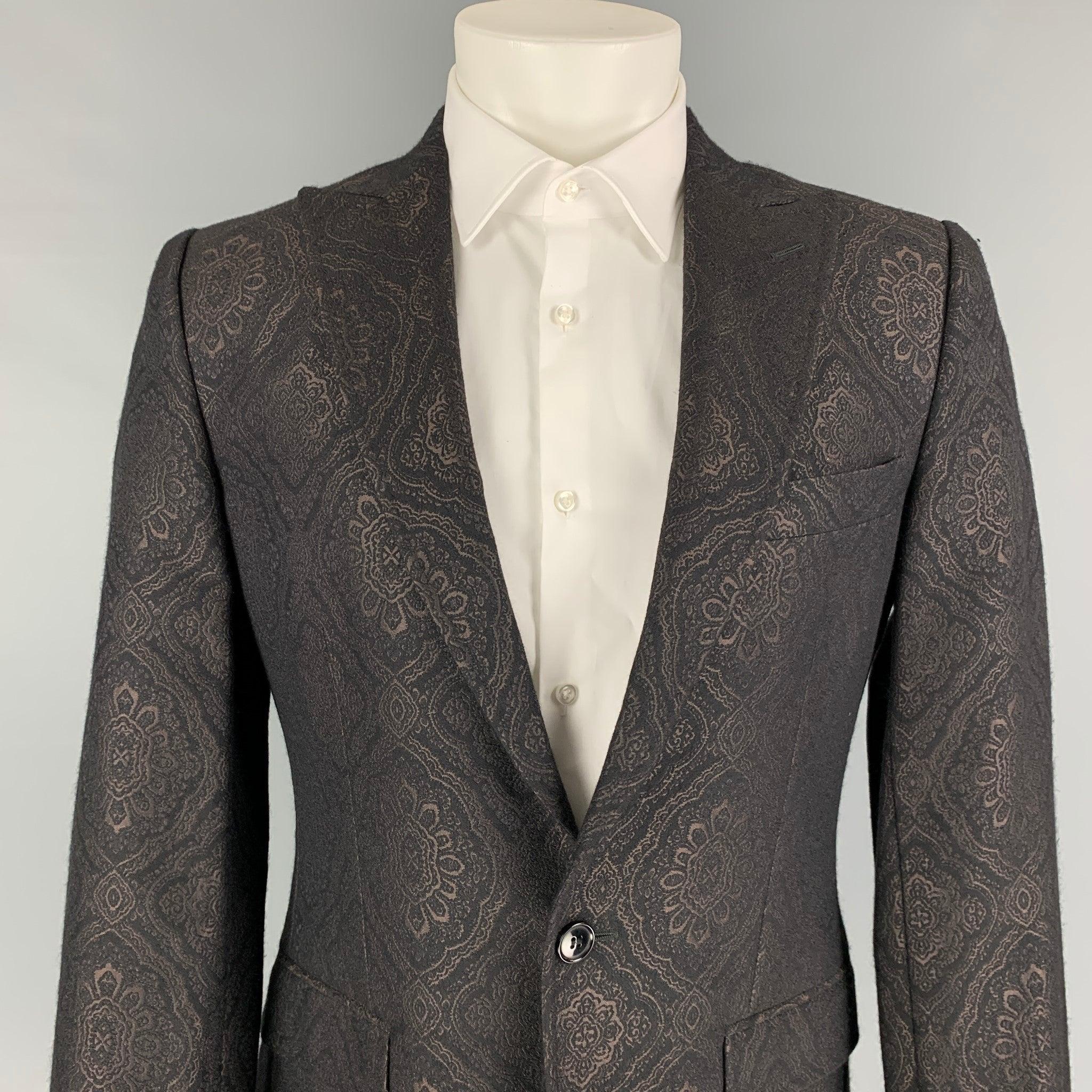 DOLCE & GABBANA sport coat comes in a black & brown jacquard wool with a full liner featuring a peak lapel, flap pockets, single back vent, and a single button closure. Made in Italy.
Very Good
Pre-Owned Condition. 

Marked:   48 

Measurements: 
