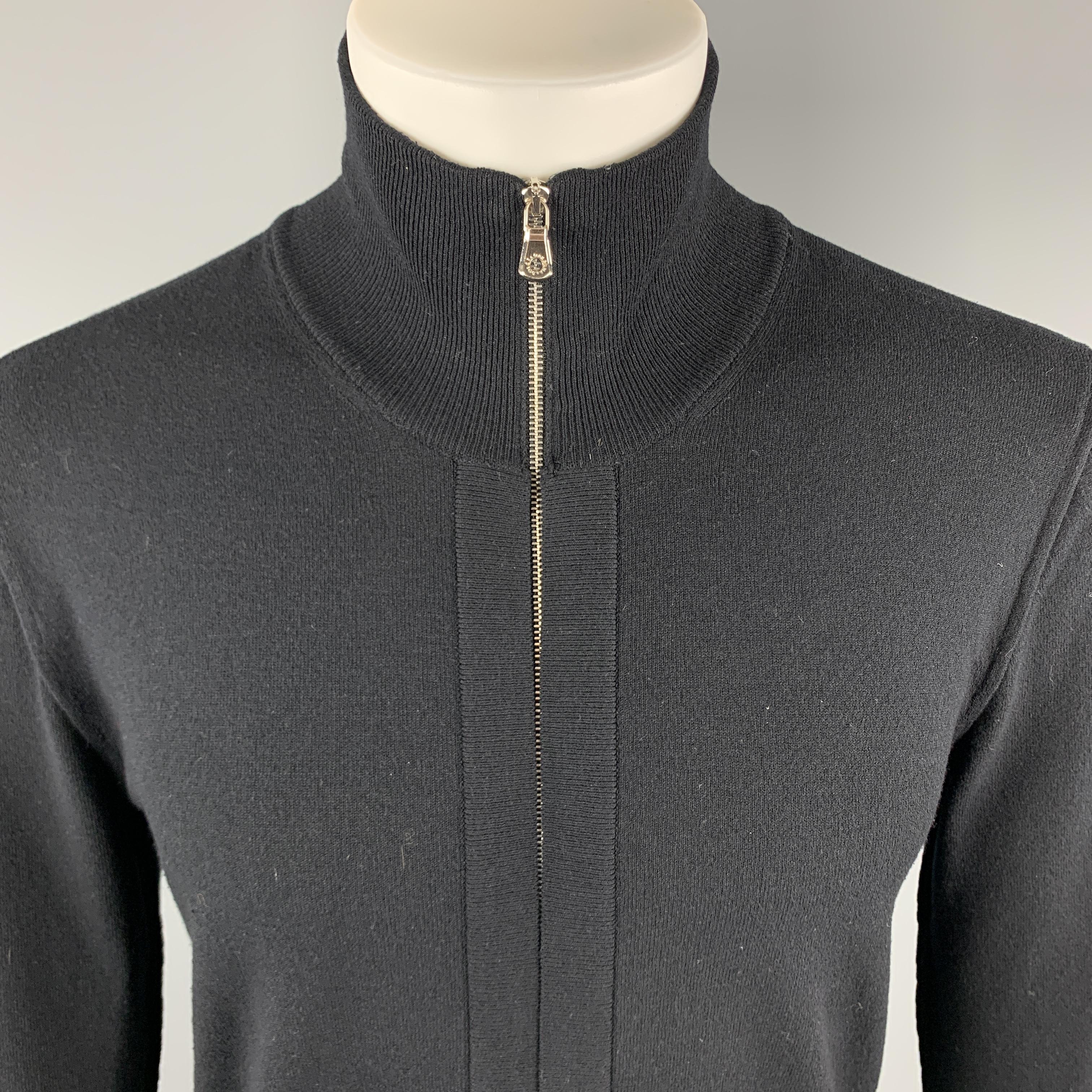 DOLCE & GABBANA Cardigan Sweater comes in a solid black rayon blend material, featuring a high collar, hidden closure at front, zip up, and ribbed cuffs and hem. Made in Italy. 

Excellent Pre-Owned Condition.
Marked: IT 48

Measurements:

Shoulder: