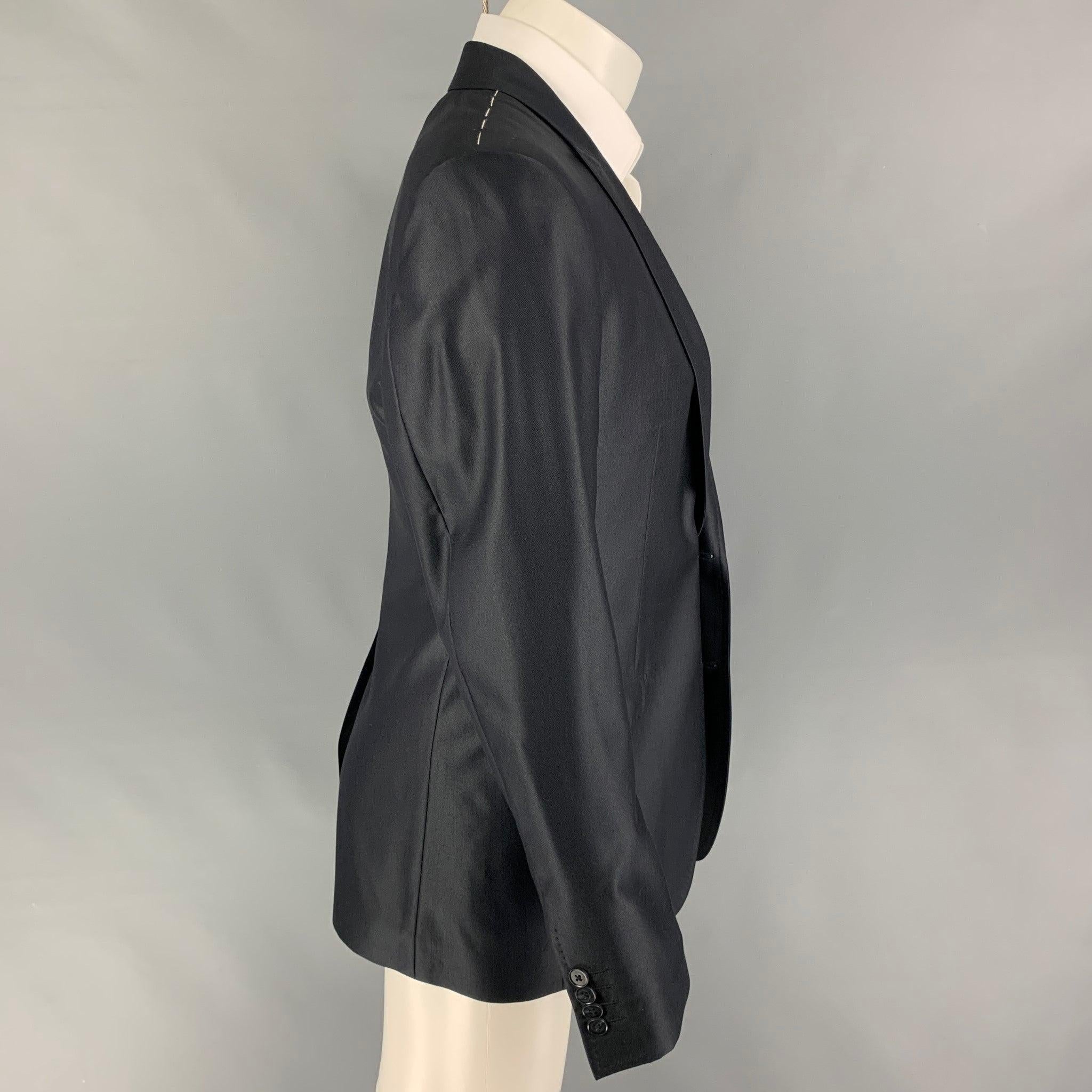 DOLCE & GABBANA 'Martini' sport coat comes in a black wool blend with a full liner featuring a peak lapel, flap pockets, single back vent, and a double button closure. Made in Italy. New with tags. 

Marked:   48 

Measurements: 
 
Shoulder: 17