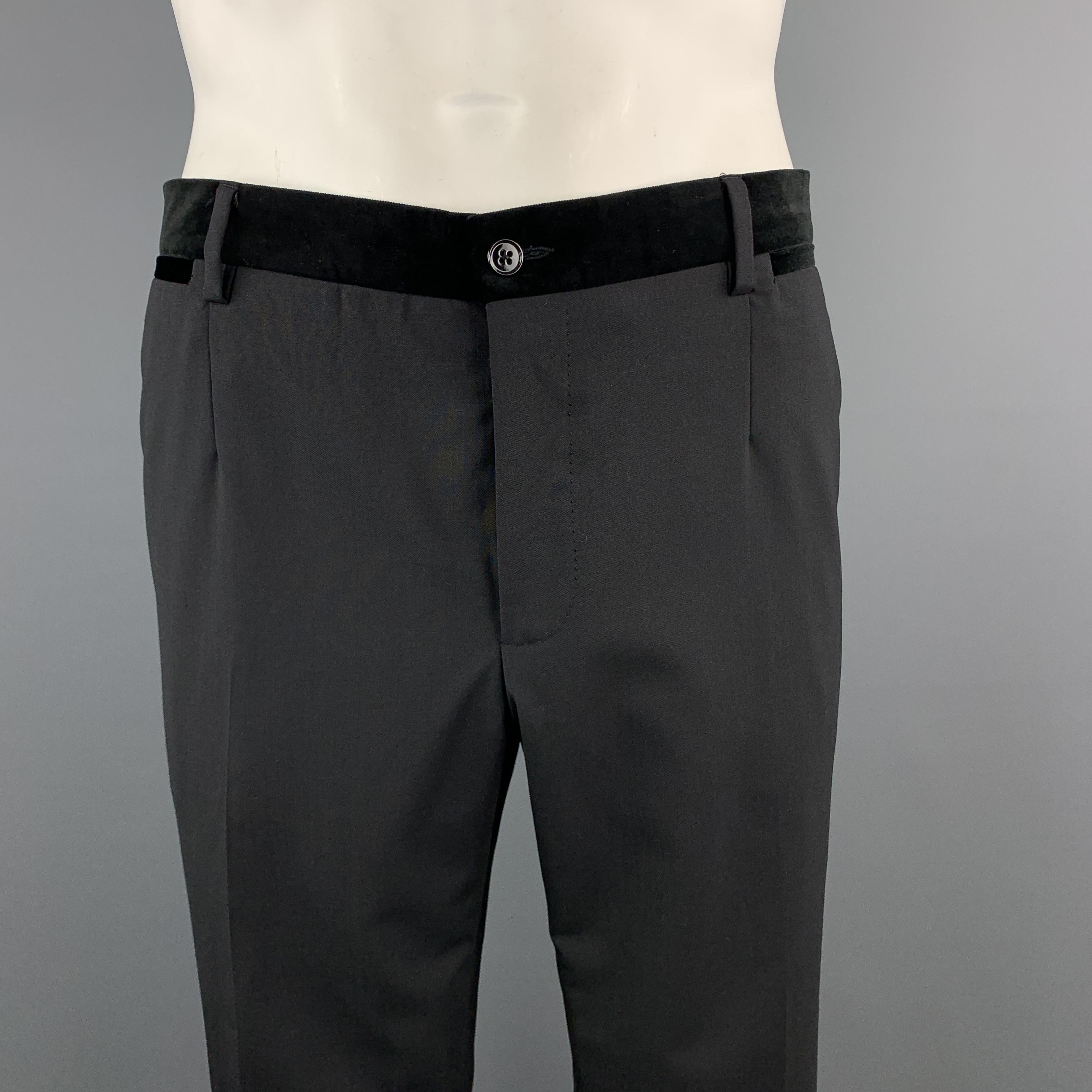 DOLCE & GABBANA dress pants come in black wool with a velvet waistband, flat front, and tuxedo side stripe. Made in Italy.

Excellent Pre-Owned Condition.
Marked: IT 54

Measurements:

Waist: 38 in.
Rise: 10 in.
Inseam: 31 in.