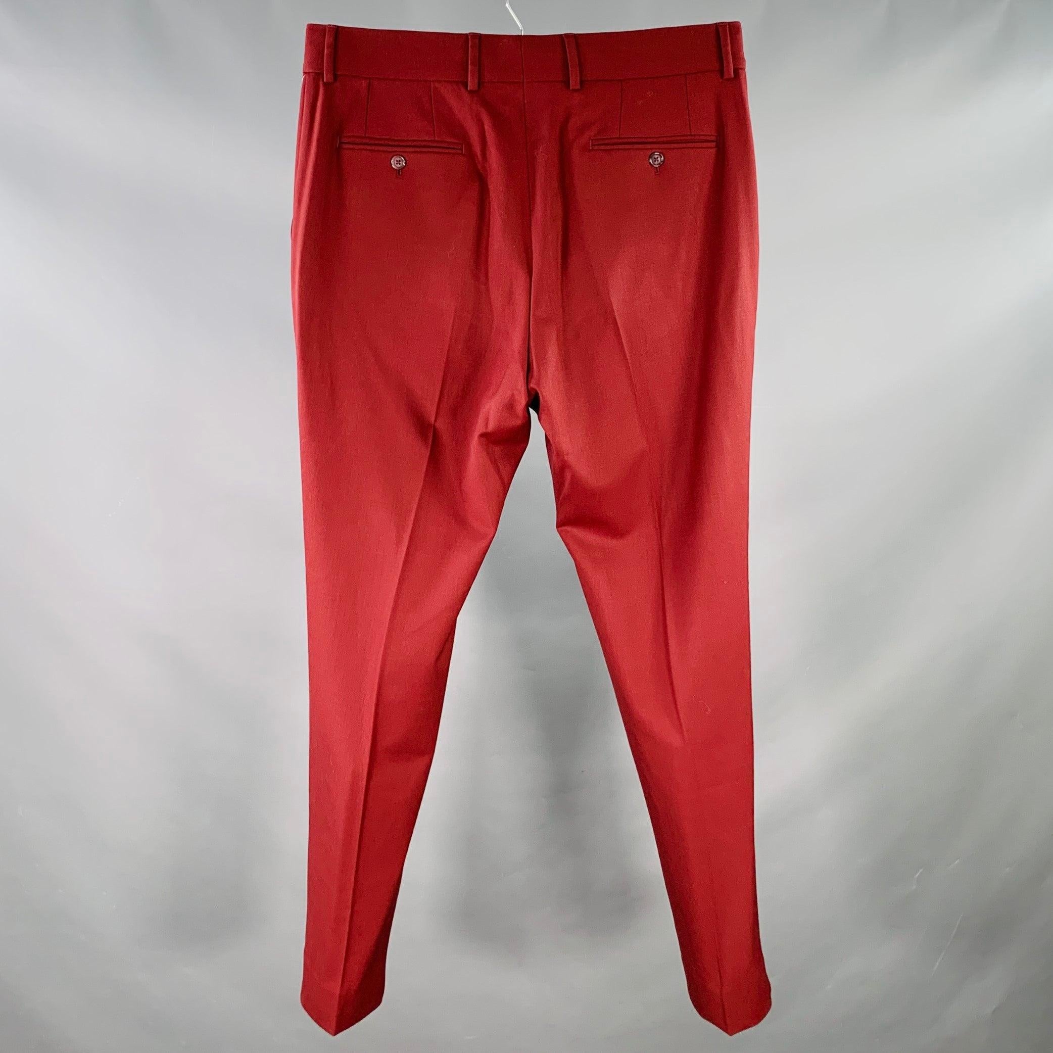 DOLCE & GABBANA dress pants
in a burgundy wool stretch blend twill featuring a flat front style, tapered leg, and zip fly closure. Made in Italy.New with Tags. 

Marked:   IT 54 

Measurements: 
  Waist: 38 inches Rise: 11.5 inches Inseam: 32 inches