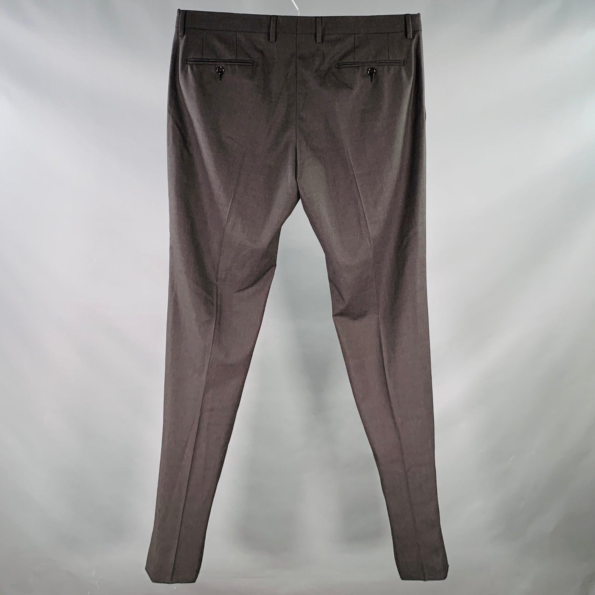 DOLCE & GABBANA dress pants
in a charcoal grey wool blend fabric featuring a flat front, tapered leg, and zip fly closure.
Made in Italy. Hem has been left unfinished in order to tailor to your perfect fit.New without Tags. 

Marked:   IT 56