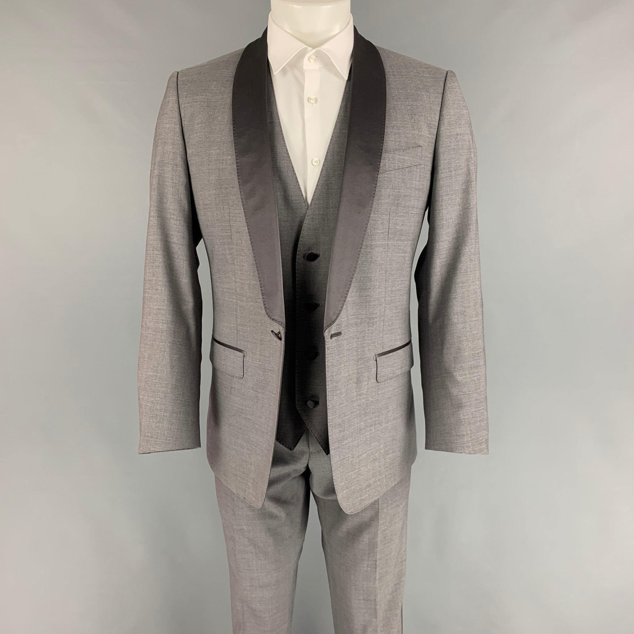 DOLCE & GABBANA 3 Piece
suit comes in a grey wool blend with a full liner and includes a single breasted, single button sport coat with shawl collar and a matching vest & flat front trousers. Made in Italy.New With Tags.  

Marked:   48
