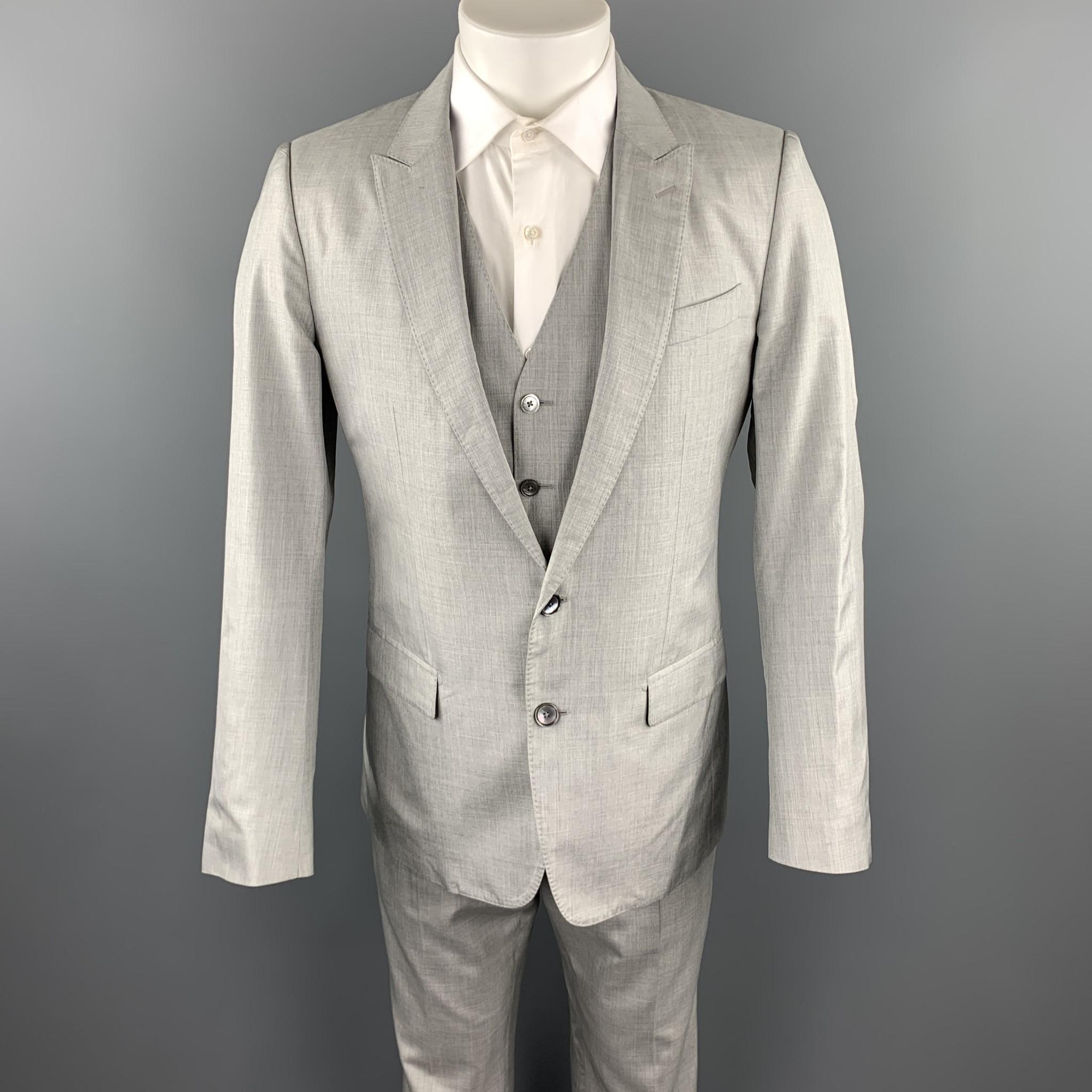 DOLCE & GABBANA suit comes in a light gray silk with a full liner and includes a single breasted, two button sport coat with a peak lapel and matching vest and flat front trousers. 

Excellent Pre-Owned Condition.
Marked: IT