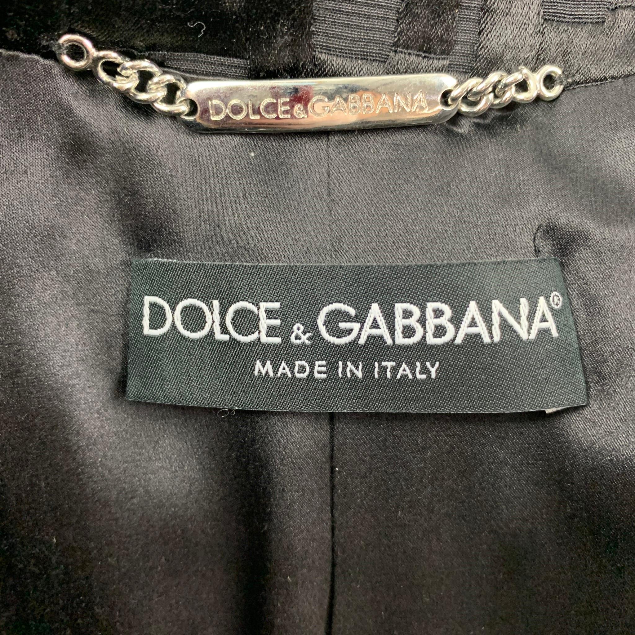 OLCE & GABBANA jacket comes in a black jacquard nylon / silk with a full liner featuring a peak lapel, buttoned details, flap pockets, and a double breasted closure. Made in Italy.

Very Good Pre-Owned Condition.
Marked: 40

Measurements:

Shoulder:
