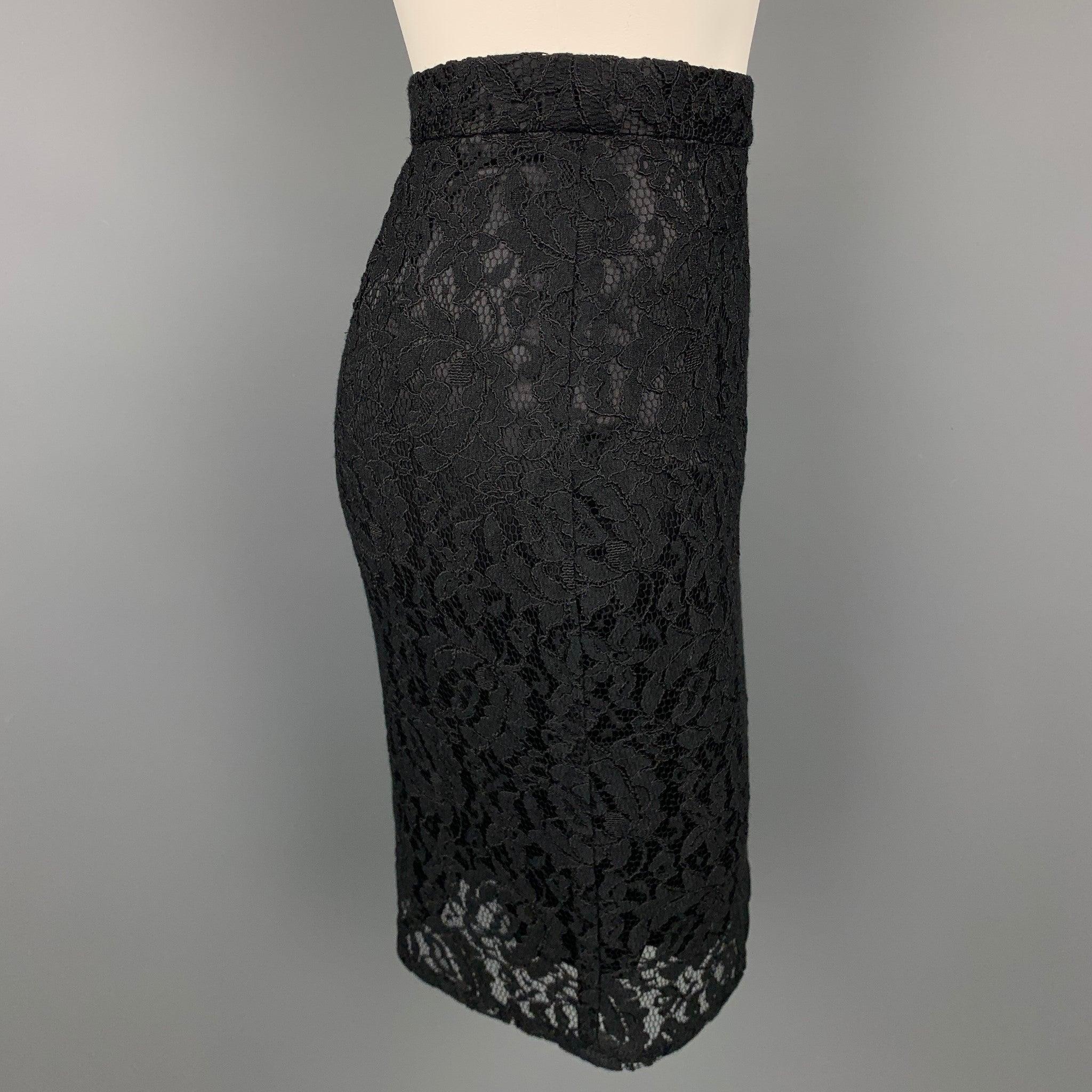 DOLCE & GABBANA skirt comes in a black lace material with a slip liner featuring a pencil style and a back zip up closure. Made in Italy.Good
Pre-Owned Condition. 

Marked:   No size marked 

Measurements: 
  Waist: 28 inches Hip: 36 inches 
Length:
