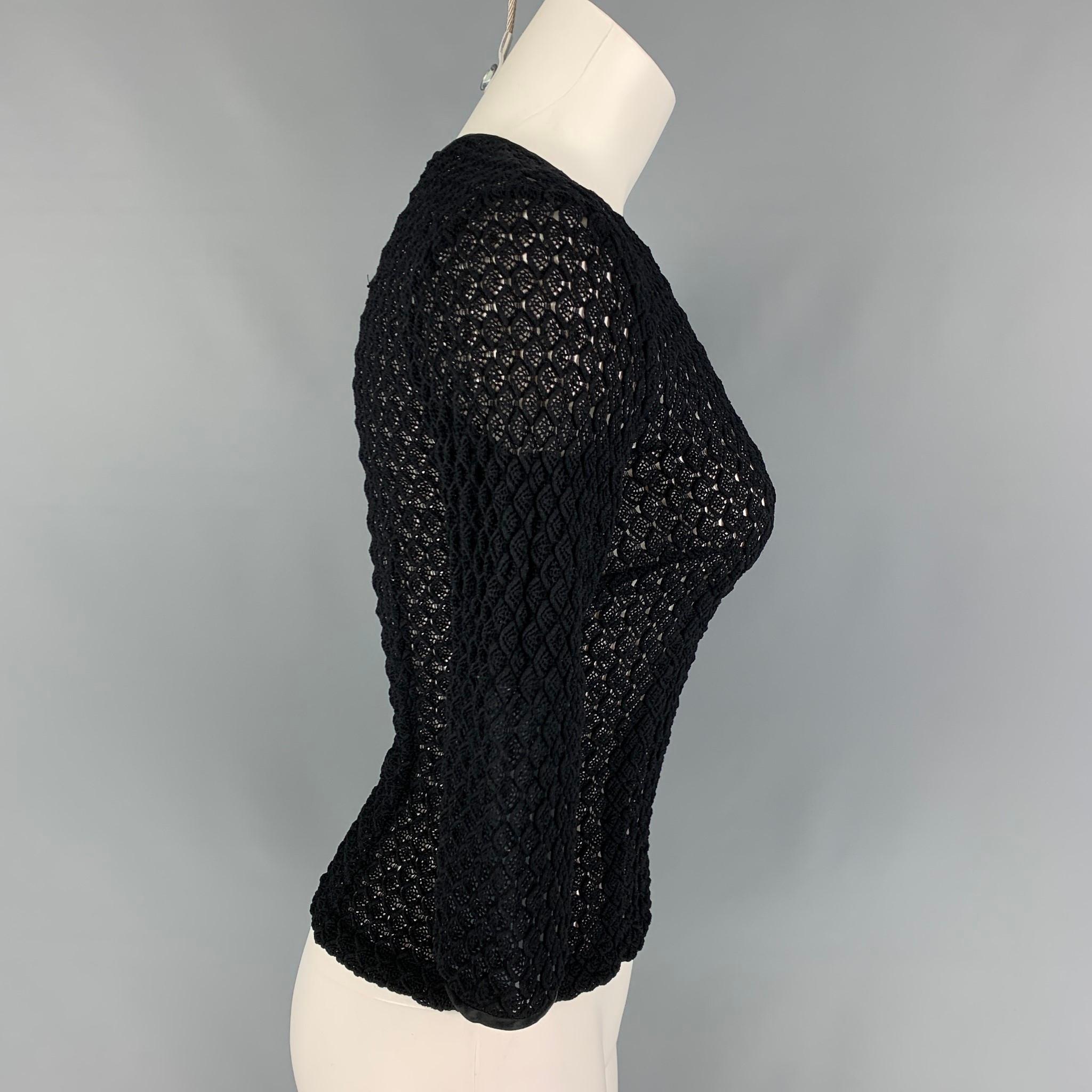 DOLCE & GABBANA dress top comes in a black knitted see through material featuring 3/4 sleeves, satin trim, and a back hook & loop closure. 

Very Good Pre-Owned Condition. Fabric tag removed.
Marked: 40

Measurements:

Shoulder: 15 in.
Bust: 30