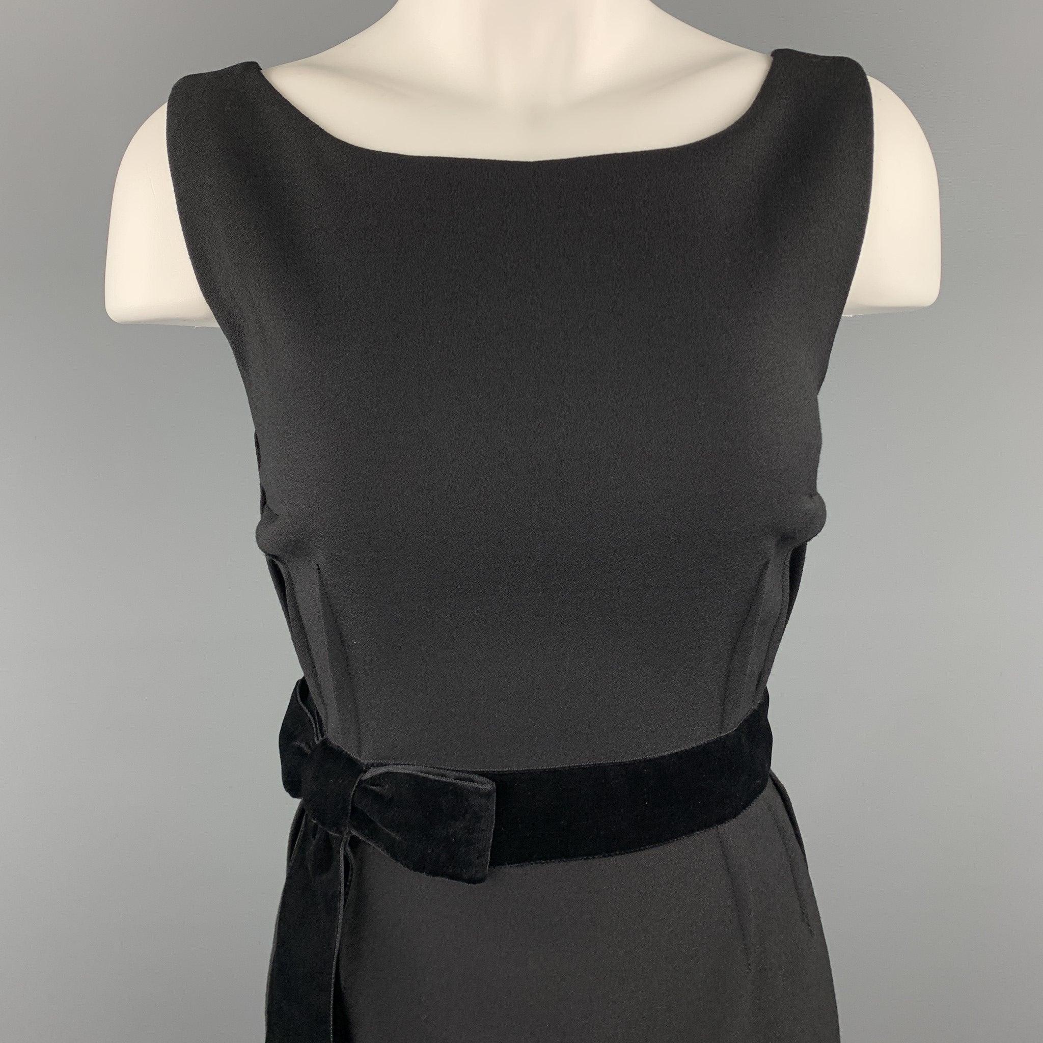 Sleeveless DOLCE & GABBANA shift dress comes in black virgin wool crepe with a boat neckline, outter dart construction, and velvet bow detail. Made in Italy.Excellent
Pre-Owned Condition. 

Marked:  IT 40 

Measurements: 
 
Shoulder:
14 inches