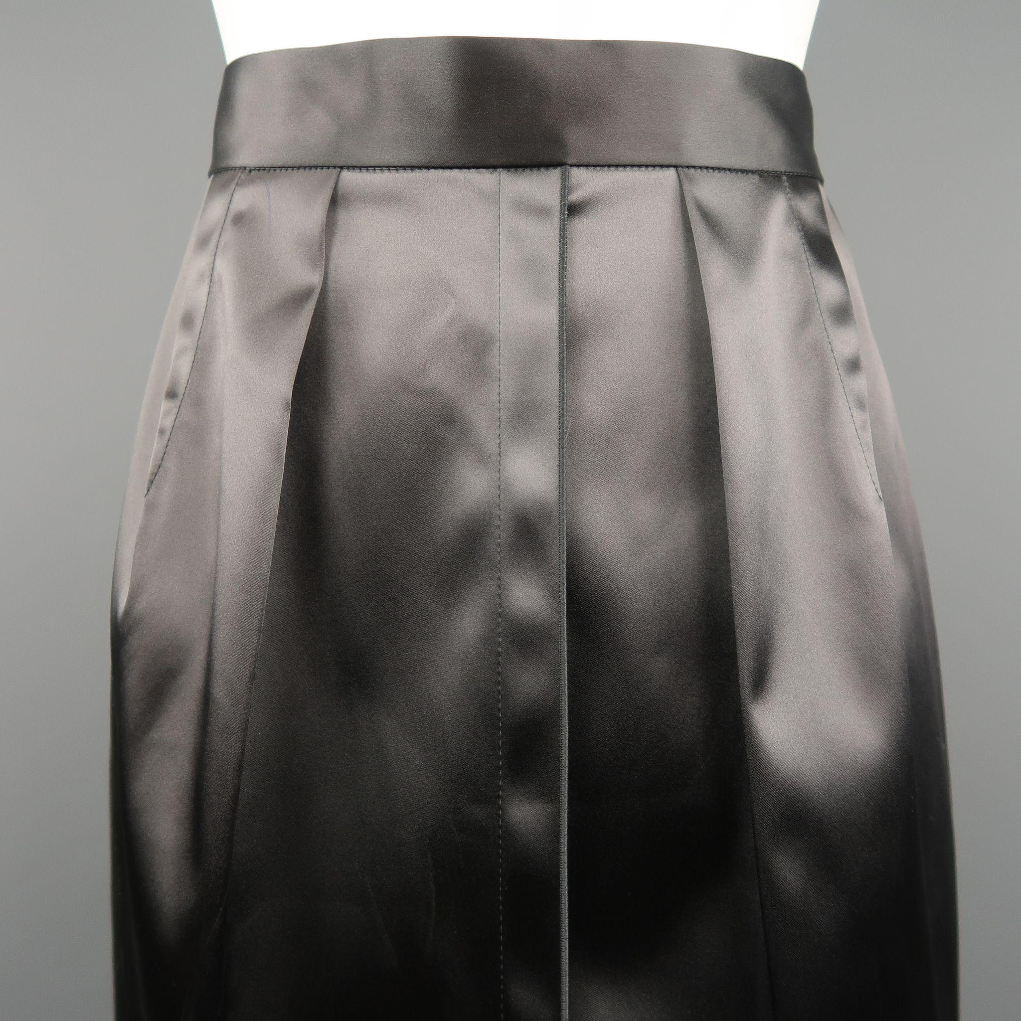 DOLCE & GABBANA pencil skirt come sin stretch satin with a high rise, pleated darts, and back zip. Made in Italy.

New with Tags.
Marked: IT 40

Measurements:
    Waist: 26 in.
    Hip: 38 in.
    Length: 25 in. 

SKU: 86440
Category: Skirt

More
