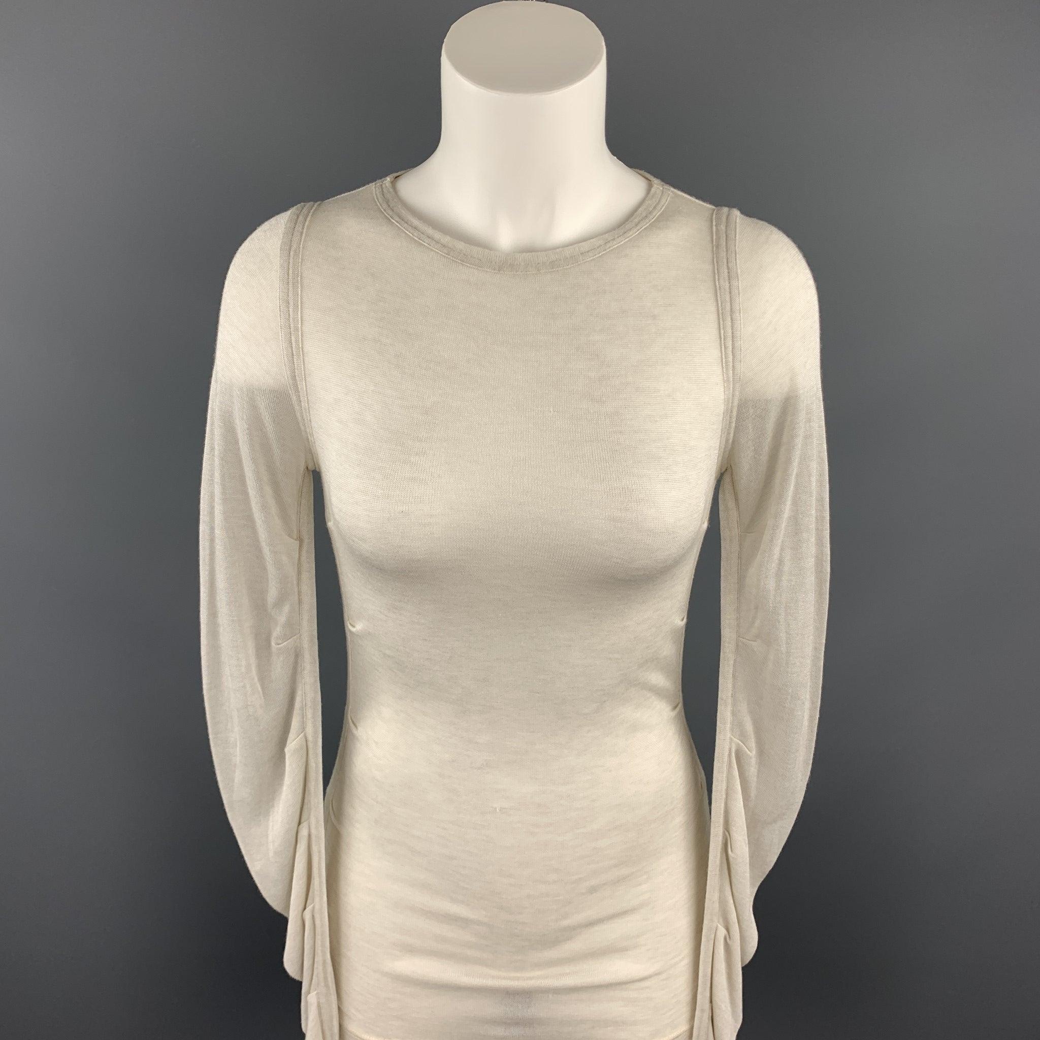 DOLCE & GABBANA pullover comes in a off white knitted fabric with ruched sleeves and a crew-neck. Made in Italy.Excellent
Pre-Owned Condition. 

Marked:   IT 40 

Measurements: 
 
Shoulder: 15 inches 
Bust: 28 inches 
Sleeve: 31 inches 
Length: 29