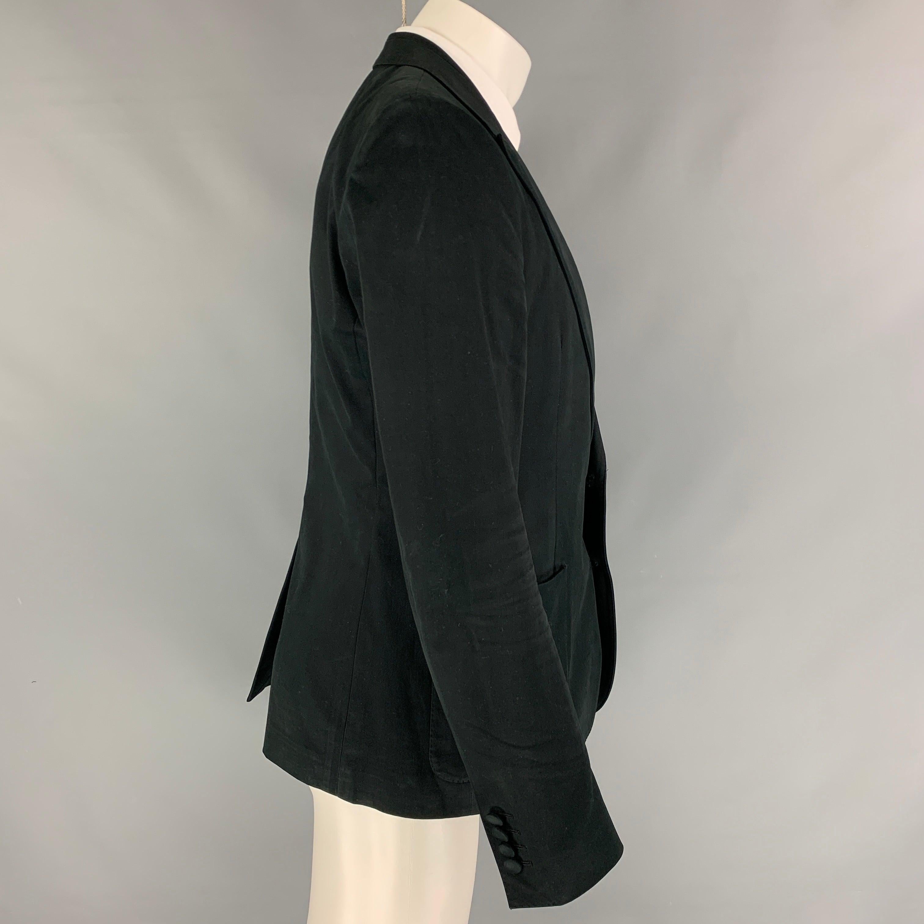 DOLCE & GABBANA sport coat in a black cotton stretch blend with a half liner featuring a peak lapel, patch pockets, single back vent, and a double button closure. Made in Italy.
Very Good
Pre-Owned Condition. 

Marked:   IT 50 

Measurements: 
