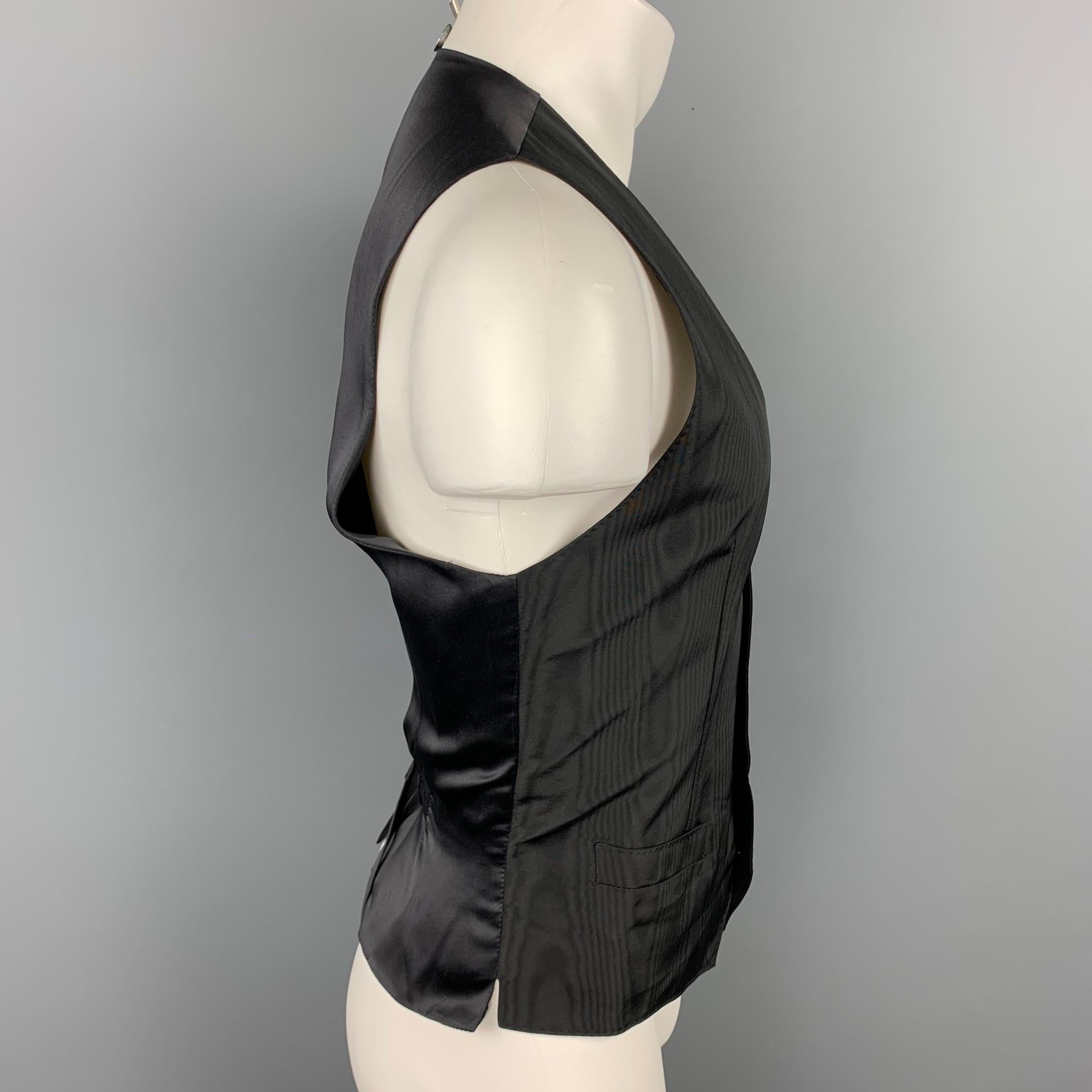 DOLCE & GABBANA dress vest comes in a black print silk with a full liner featuring a back belt , slit pockets, and a buttoned closure. Made in Italy.

Very Good Pre-Owned Condition.
Marked: 50

Measurements:

Shoulder: 14 in.
Chest: 38 in.
Length: