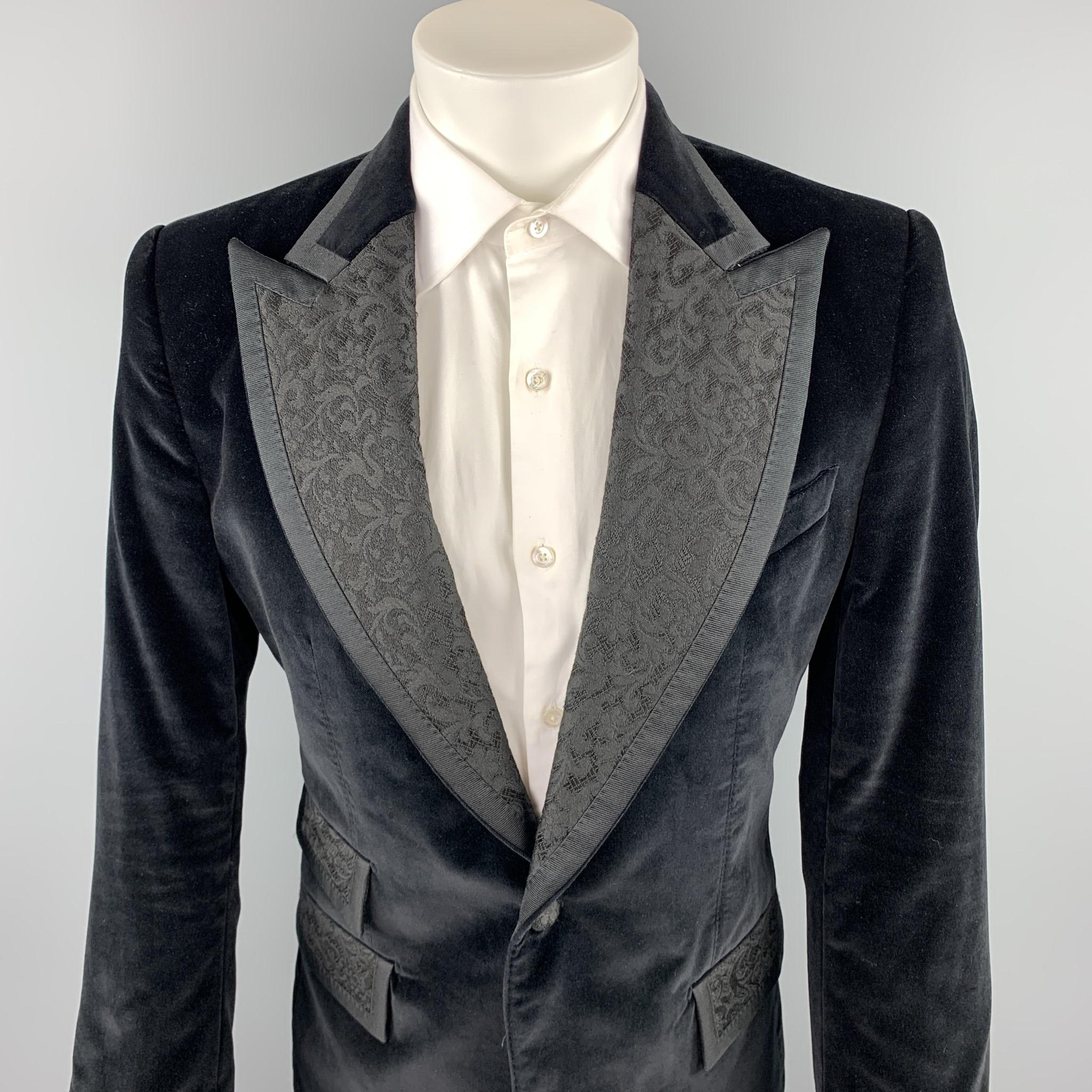 DOLCE & GABBANA sport coat comes in a black velvet with a full black liner featuring a jacquard peak lapel, flap pockets, and a single button closure. Made in Italy.

Excellent Pre-Owned Condition.
Marked: IT 50

Measurements:

Shoulder: 18 in.