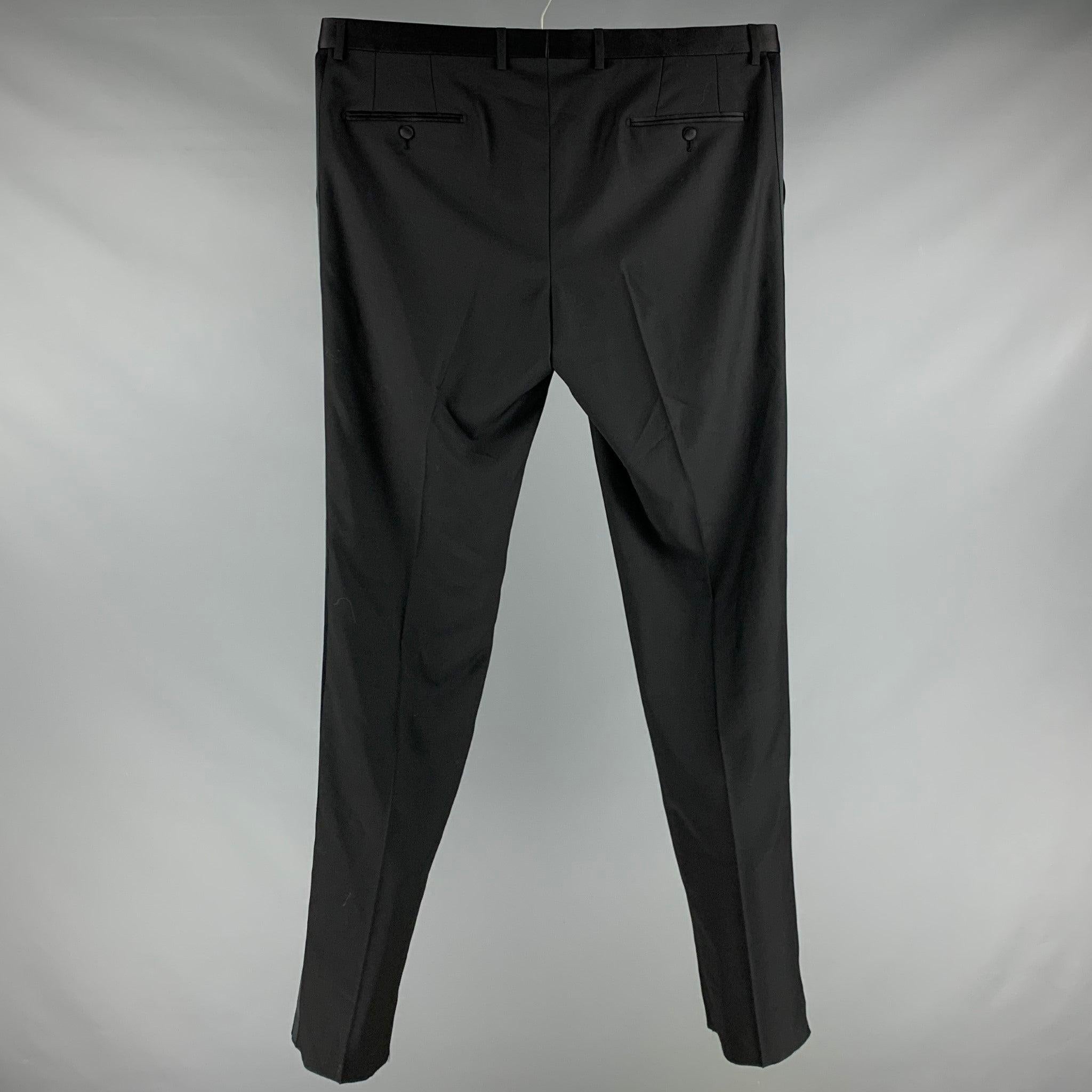 DOLCE & GABBANA dress
pants in a black wool blend fabric featuring satin waistband and stripes, flat front style, and zip fly closure. Made in Italy.Very Good Pre-Owned Condition. 

Marked:  IT 60 

Measurements: 
 Waist: 40 inches Rise: 8.5 inches