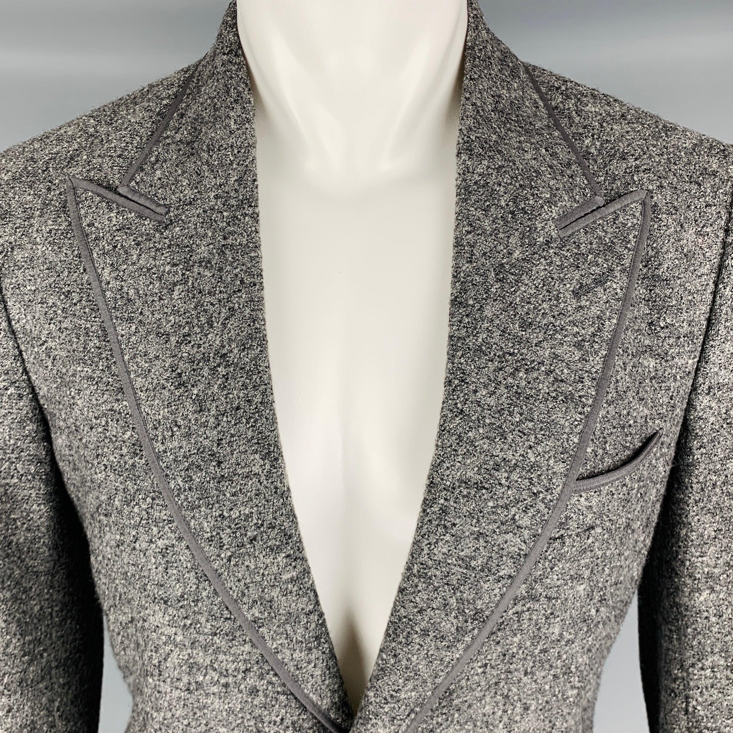 DOLCE & GABBANA sport coat
in a heather grey and black wool fabric featuring peak lapel, double vented back, and double button closure. Made in Italy.Very Good Pre-Owned Condition. Marks under arms. 

Marked:   IT 50 

Measurements: 
 
Shoulder: 17